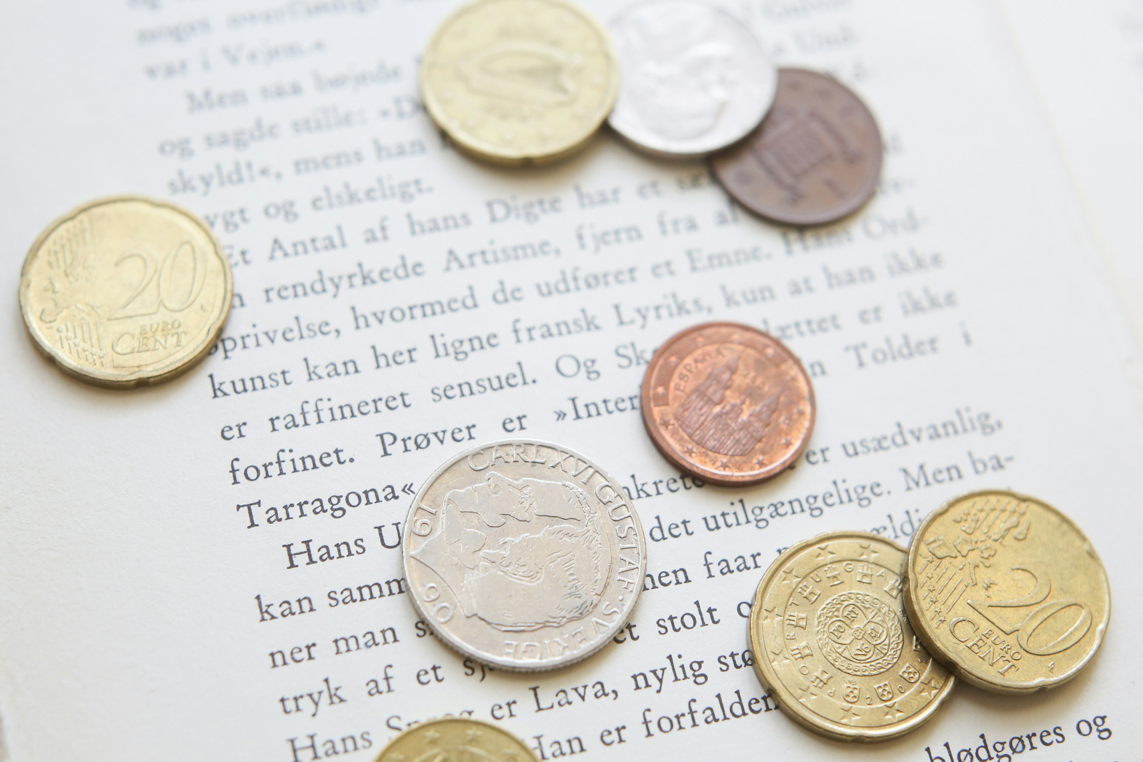 Coins scattered on a book page