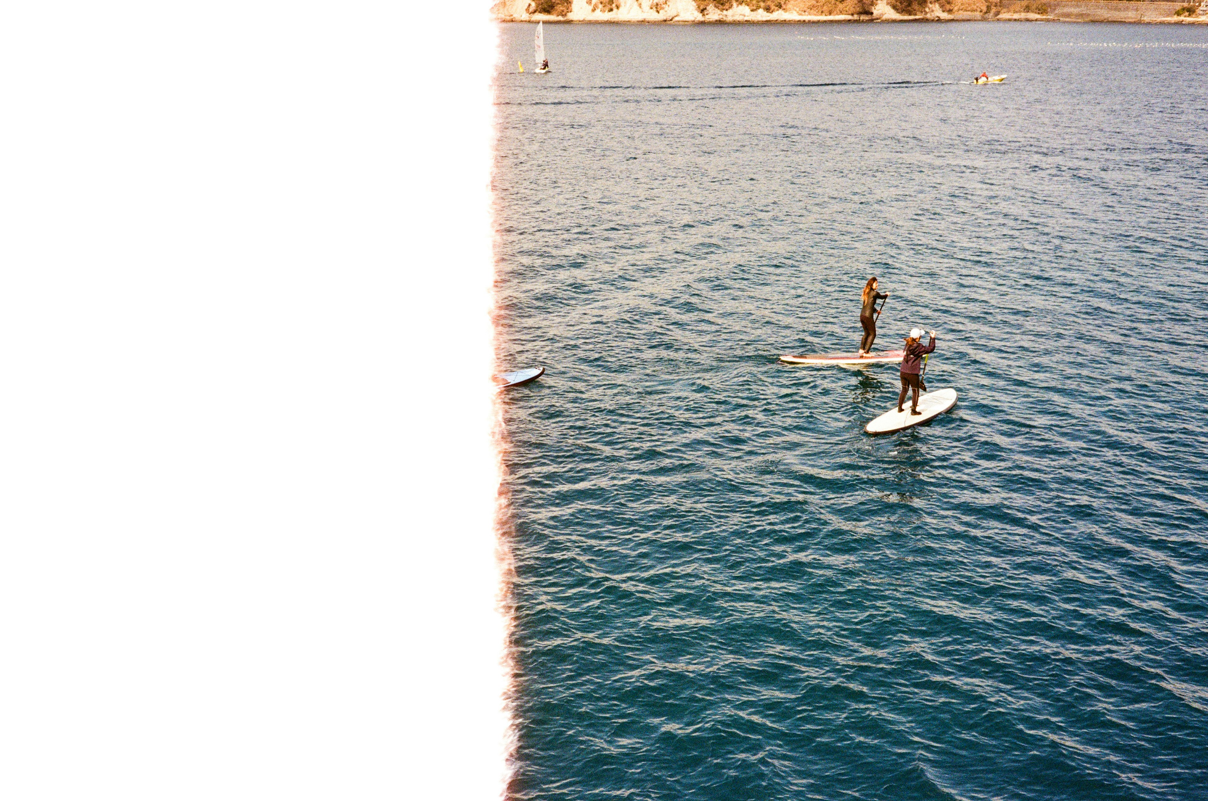 People enjoying stand-up paddleboarding on the water