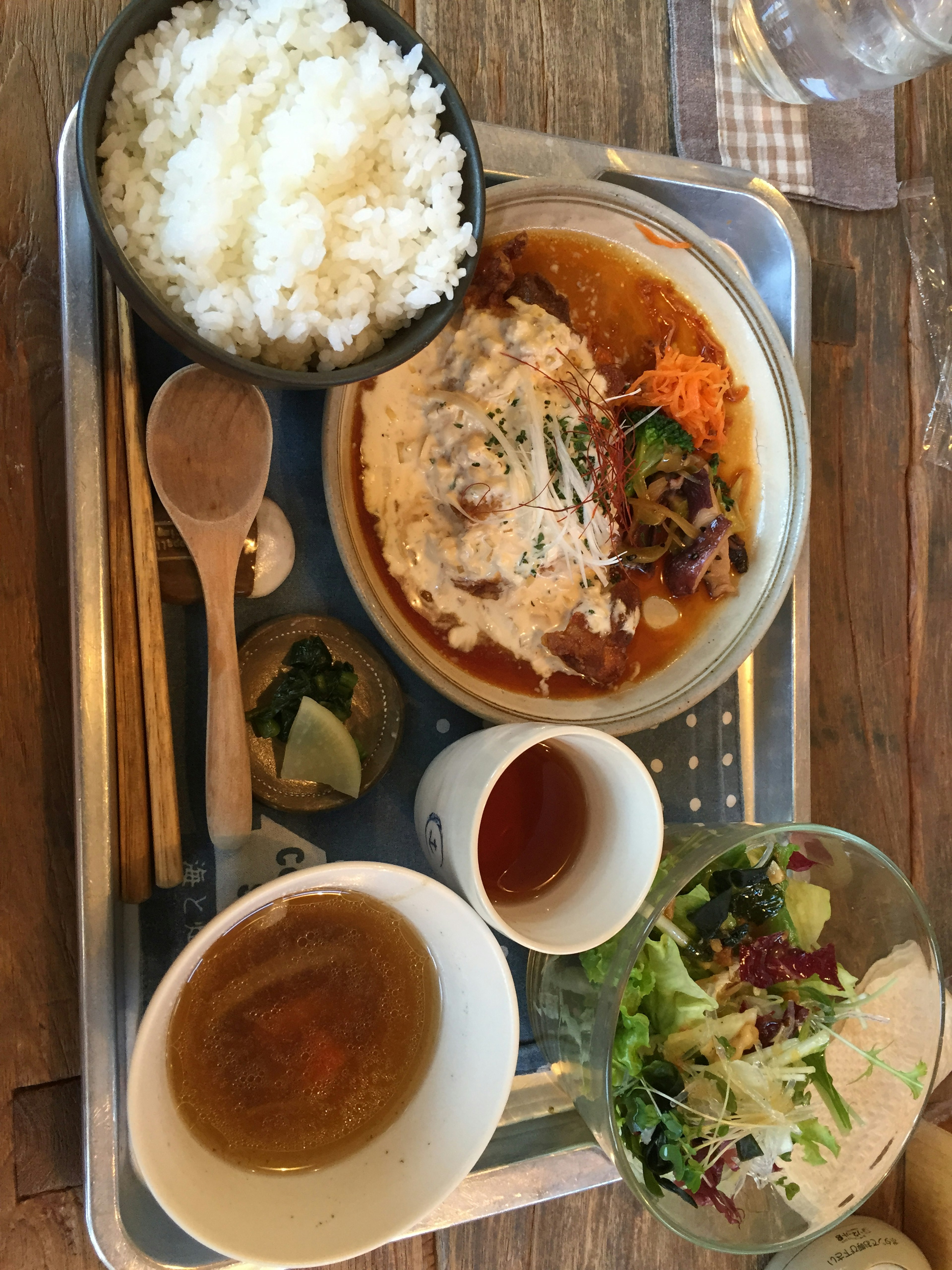 Japanese lunch plate featuring rice, salad, and a main dish