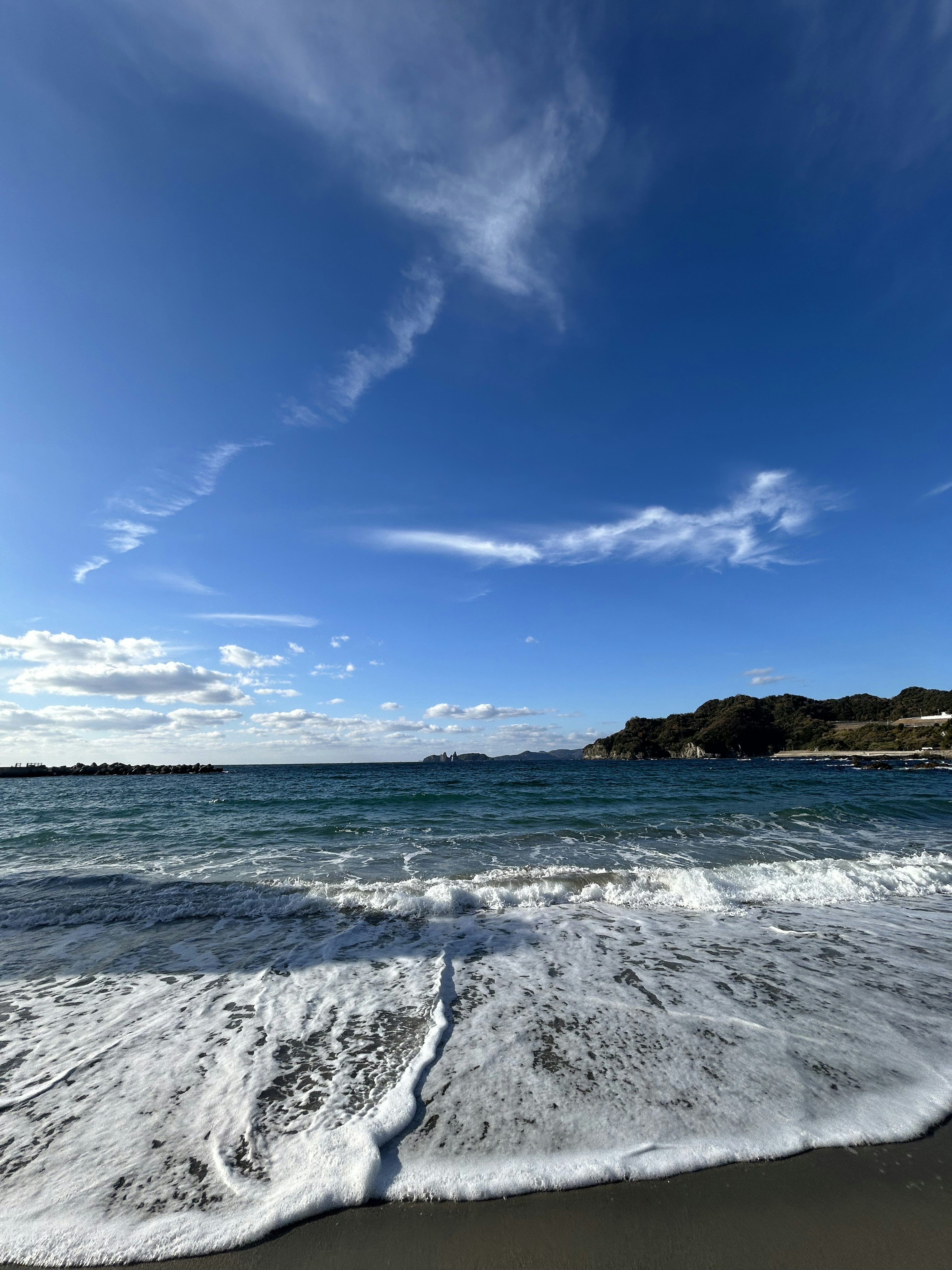 Beautiful coastal view with blue sky and crashing waves