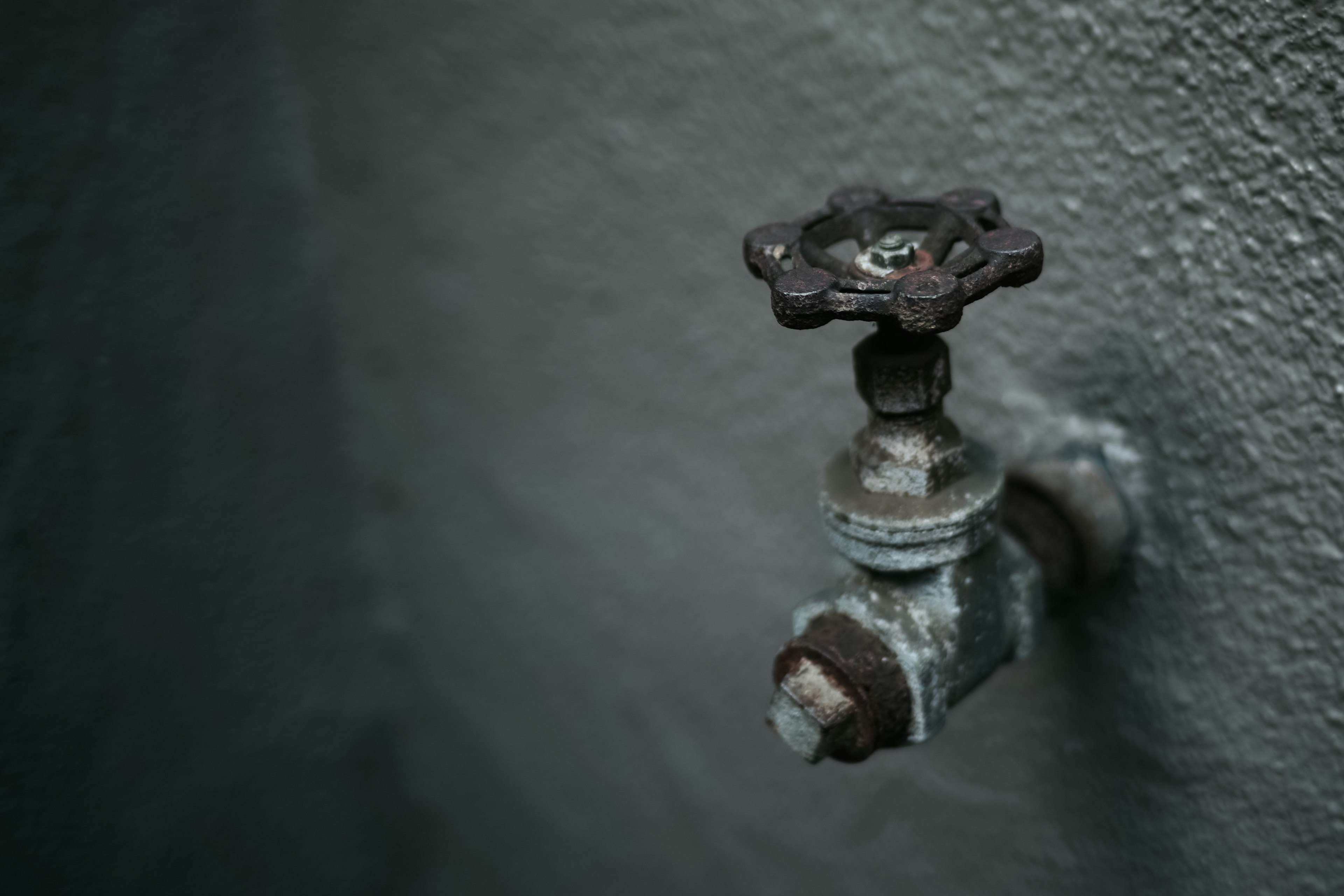 An old metal faucet mounted on a wall