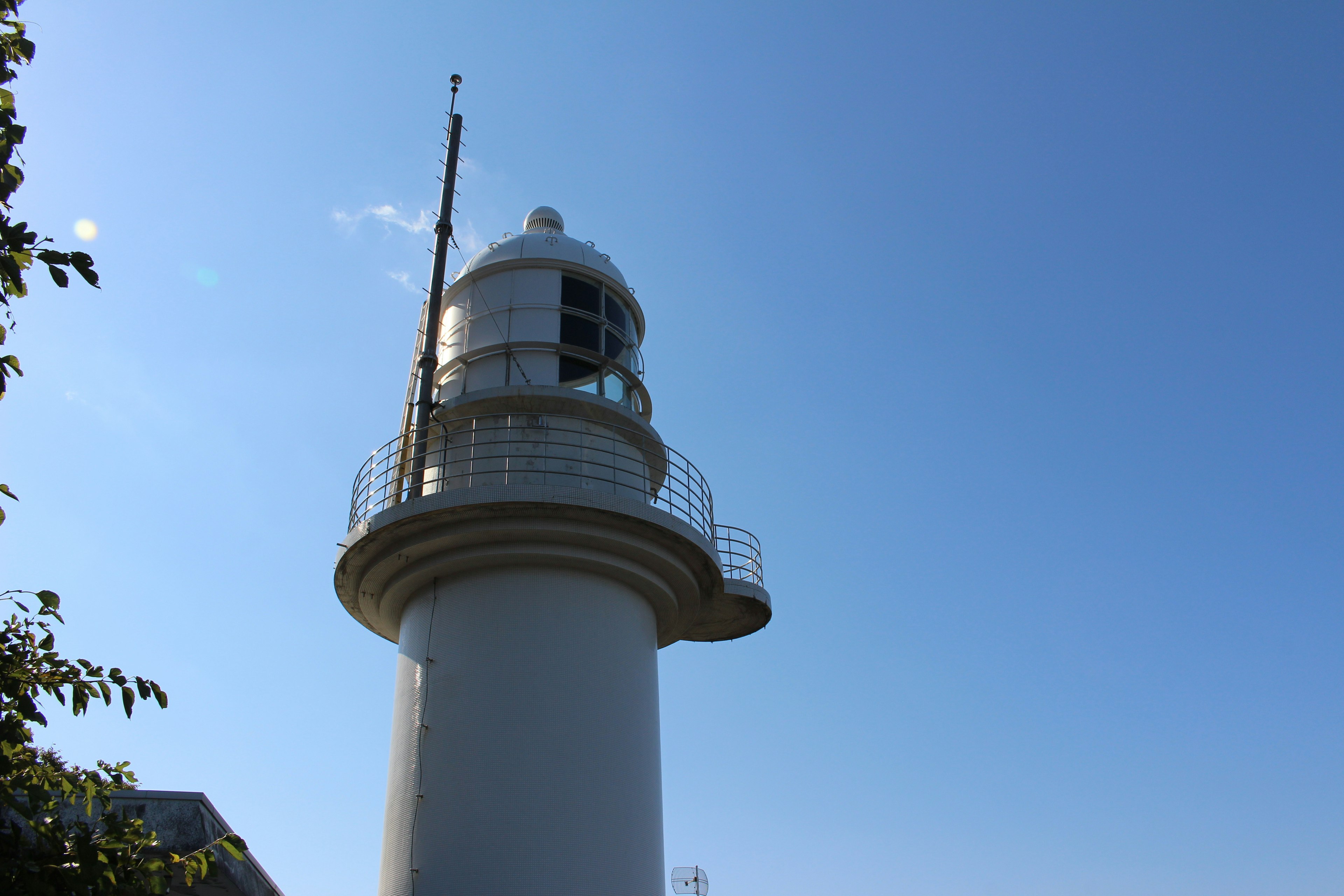 White lighthouse against a clear blue sky