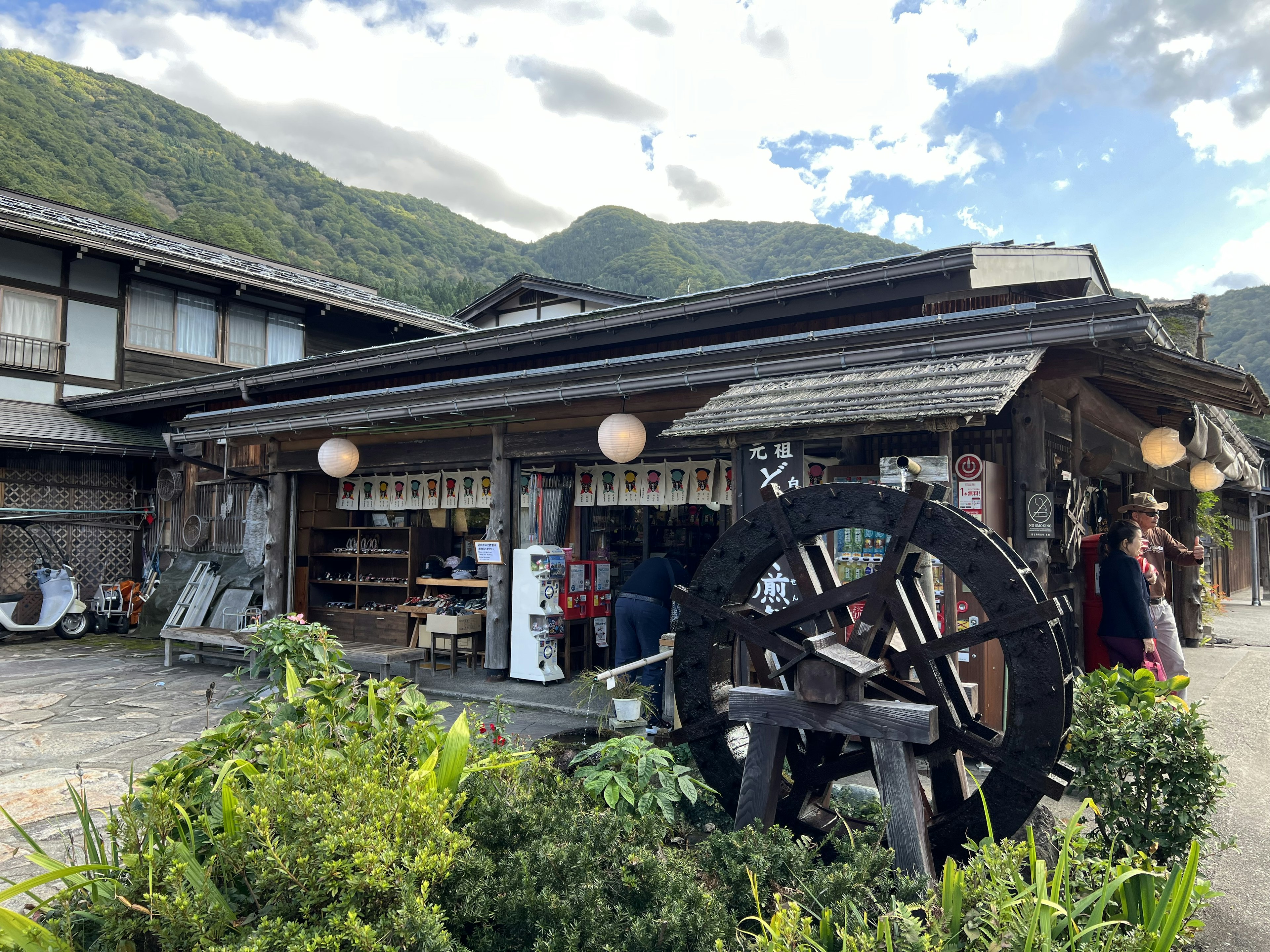 Traditional Japanese shop exterior with mountains in the background