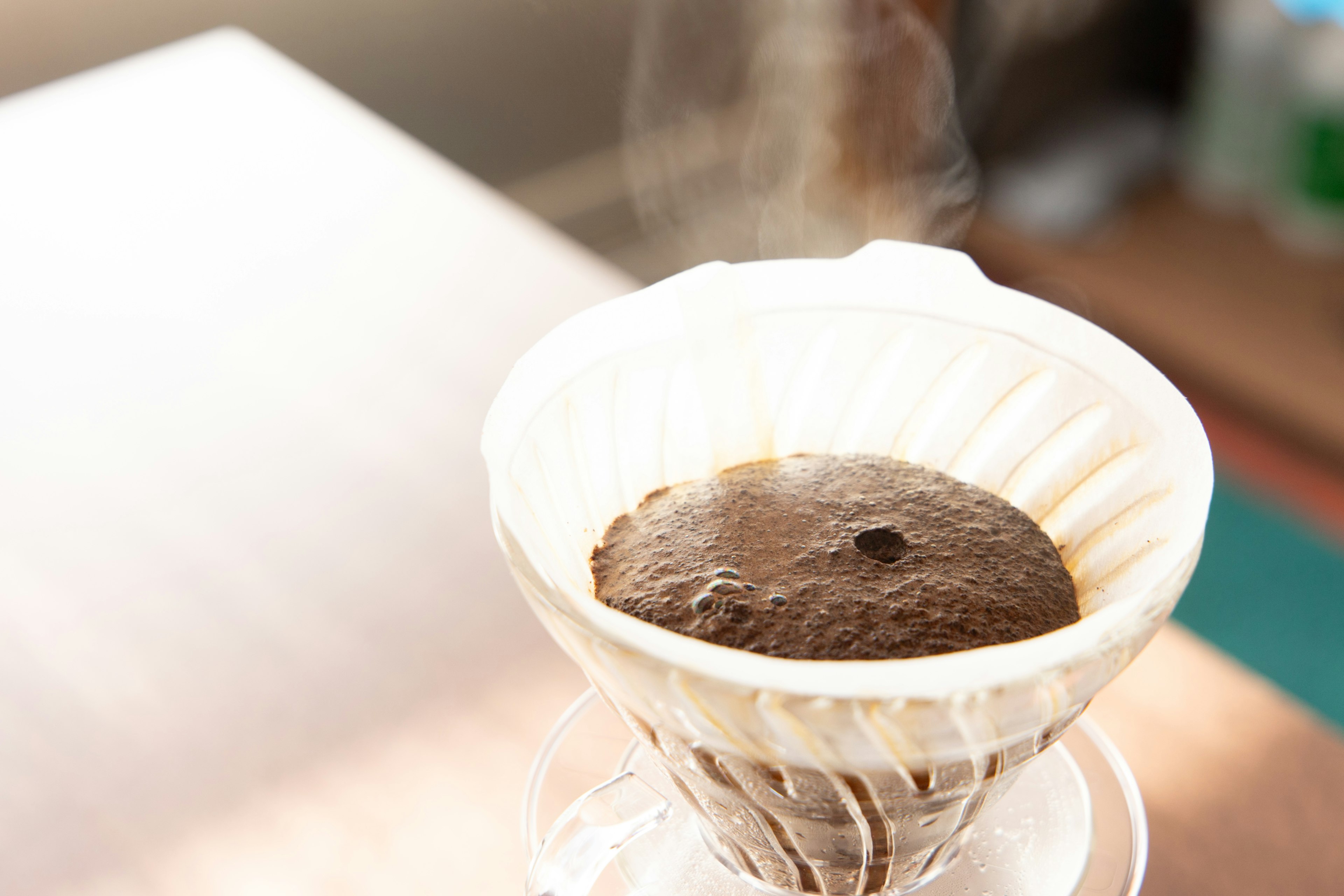 Coffee brewing in a dripper with steam rising