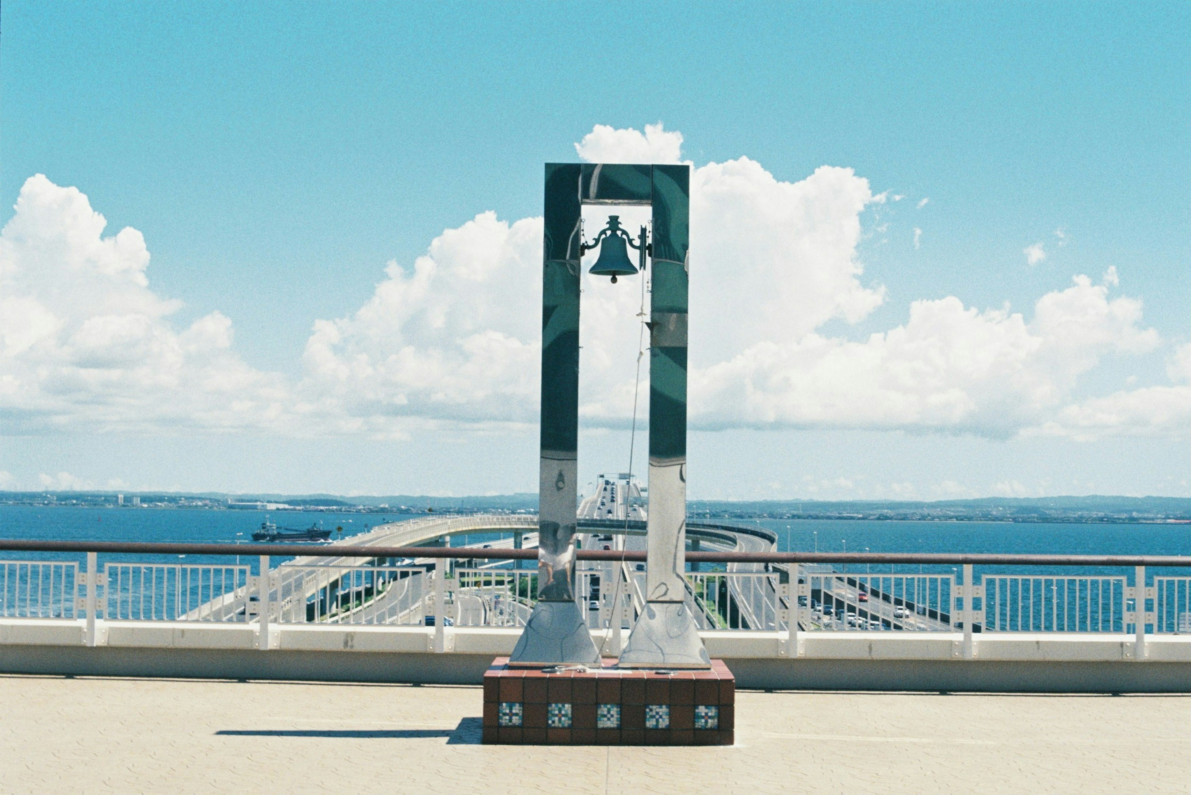 Bell monument under blue sky with ocean view