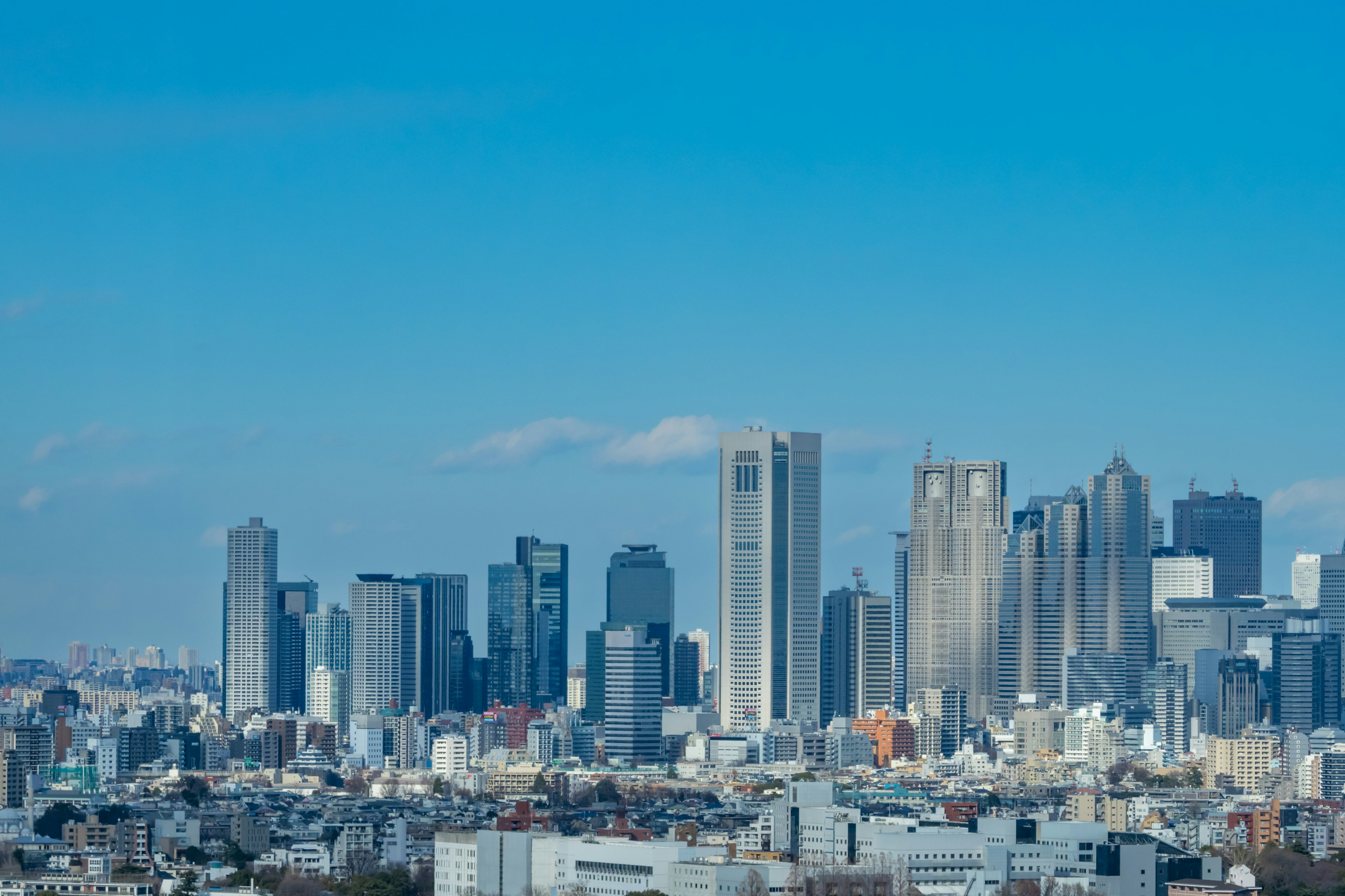 A skyline view of Tokyo with skyscrapers and clear blue sky