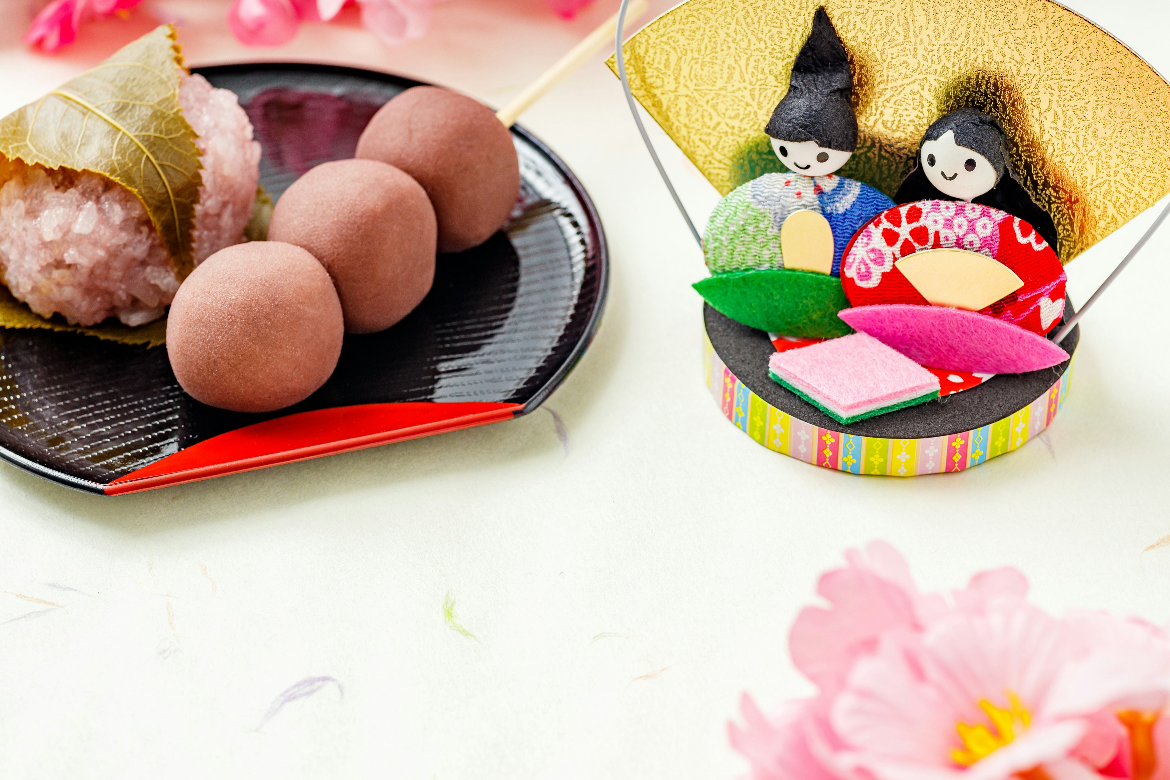 A beautiful table featuring traditional Japanese sweets and hina doll decorations