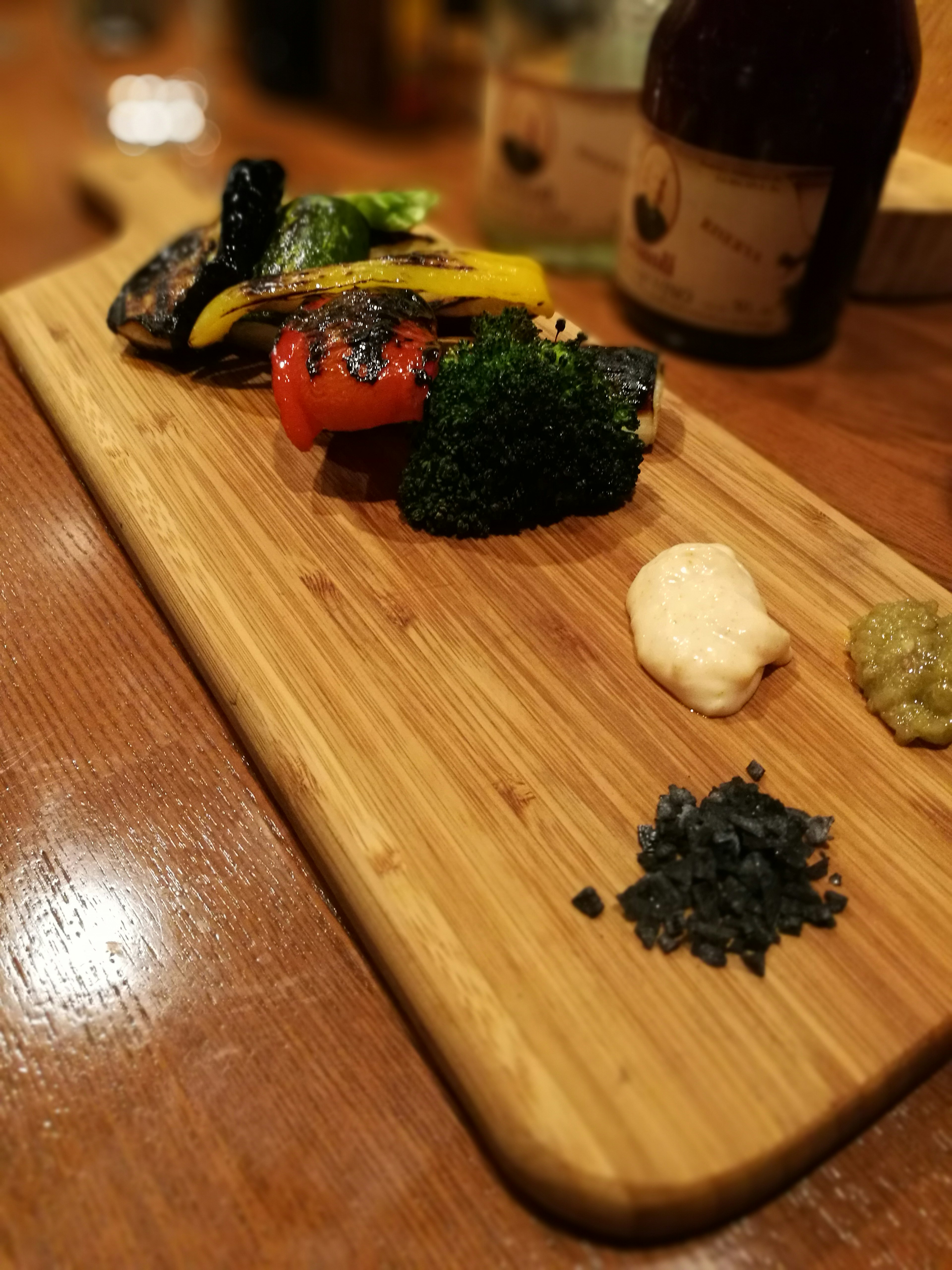 Colorful assortment of vegetables and condiments on a wooden board