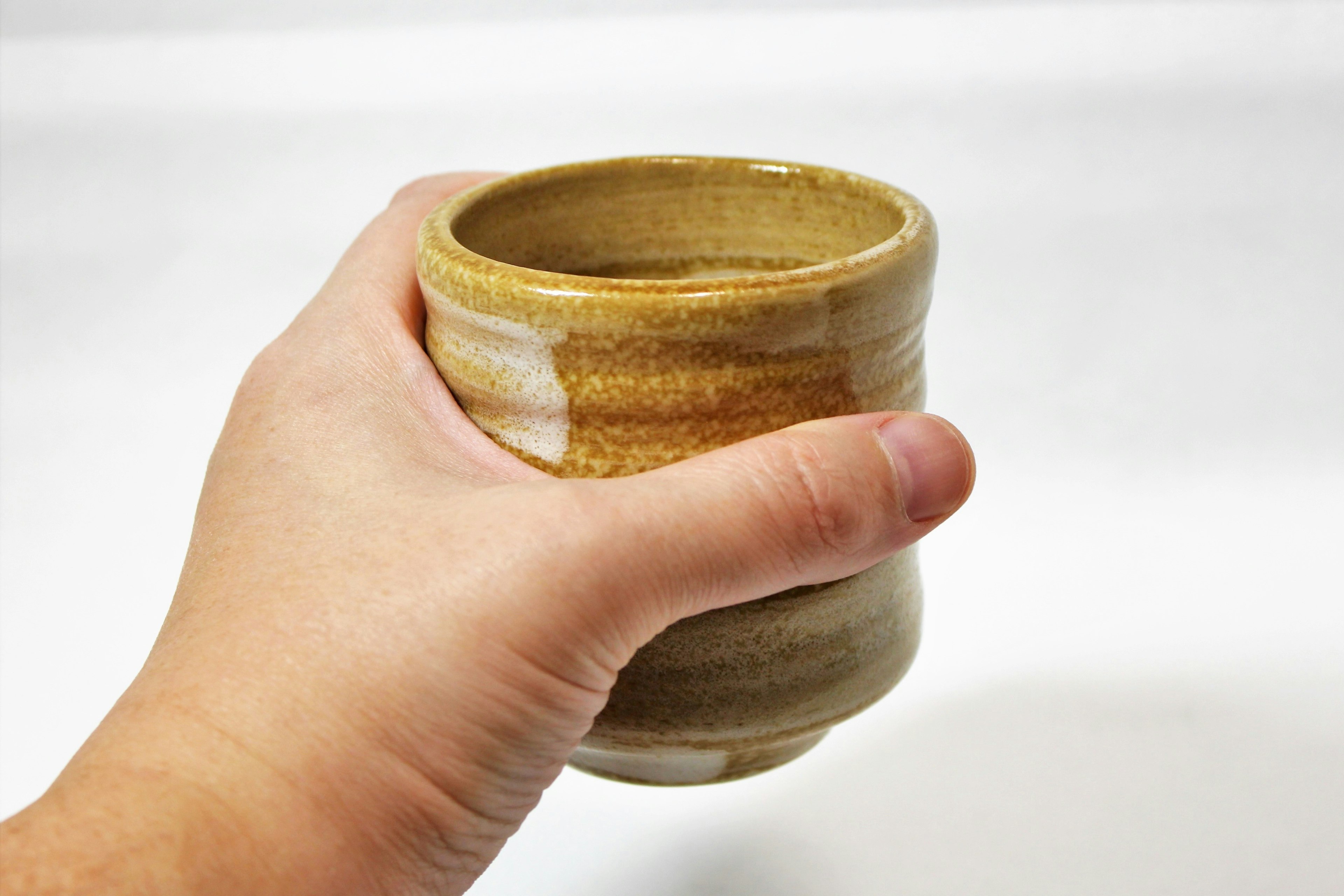 Close-up of a ceramic cup held in hand