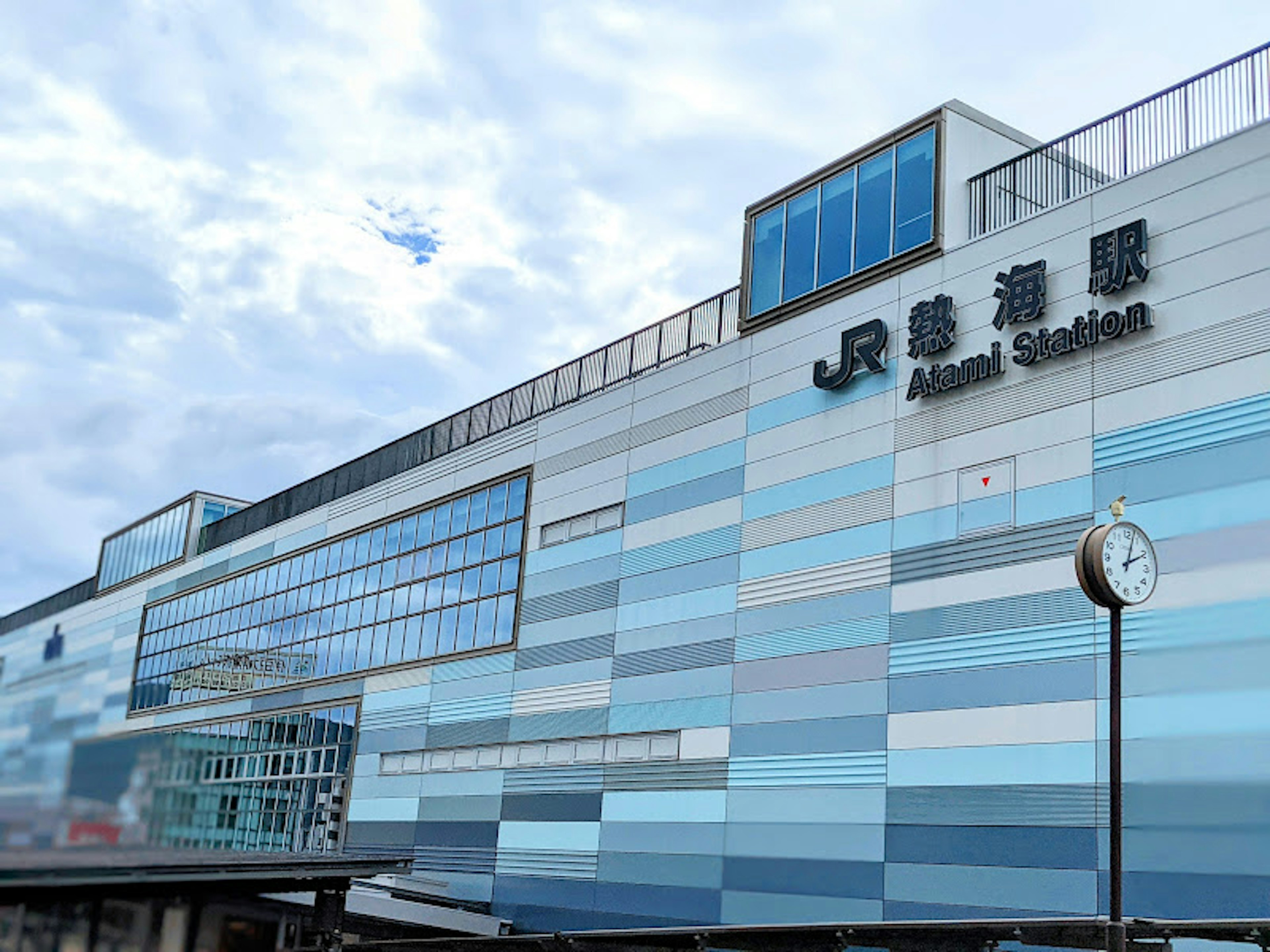 Exterior of JR Amani Station featuring blue and white striped design