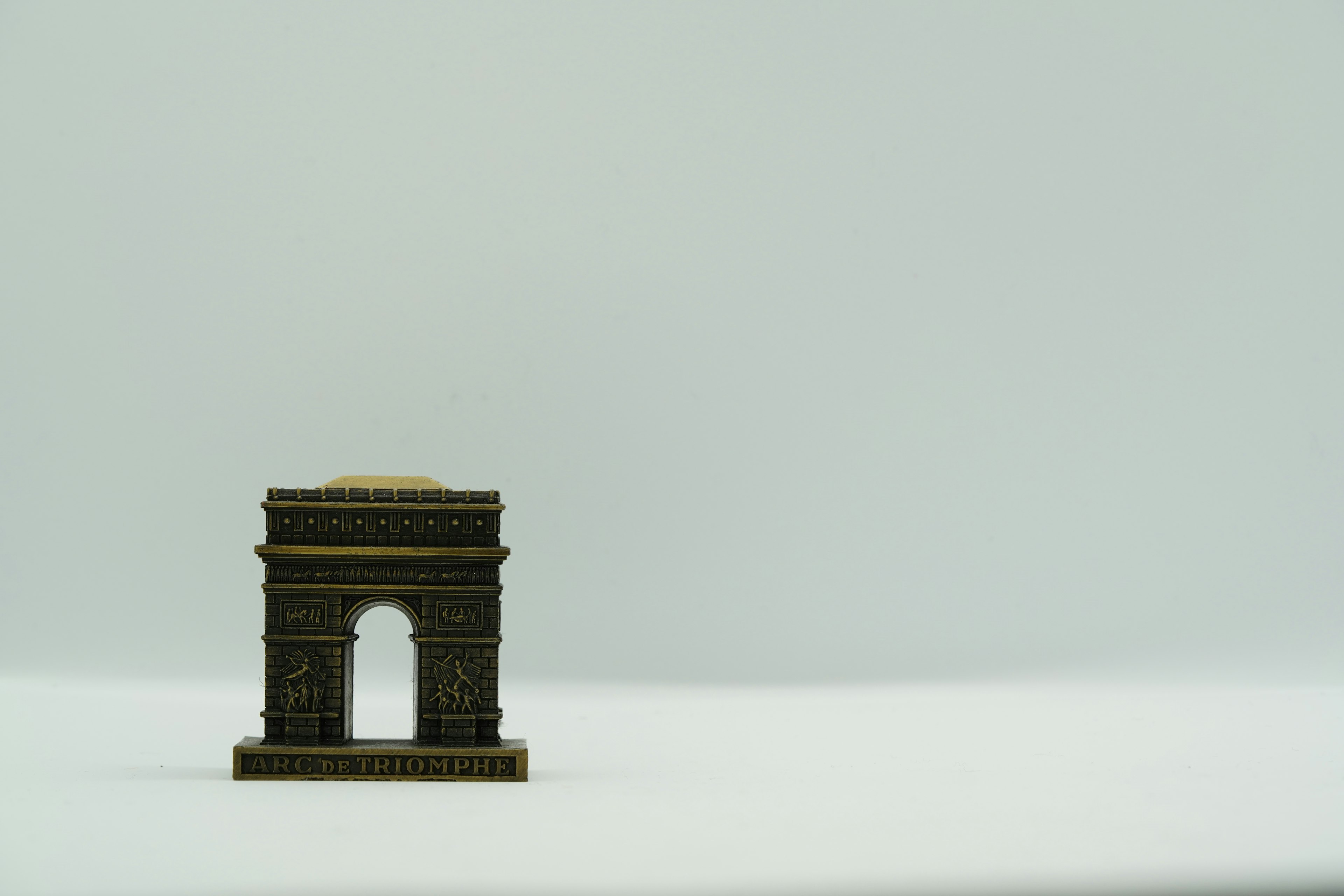 A small arch-shaped building model on a white background