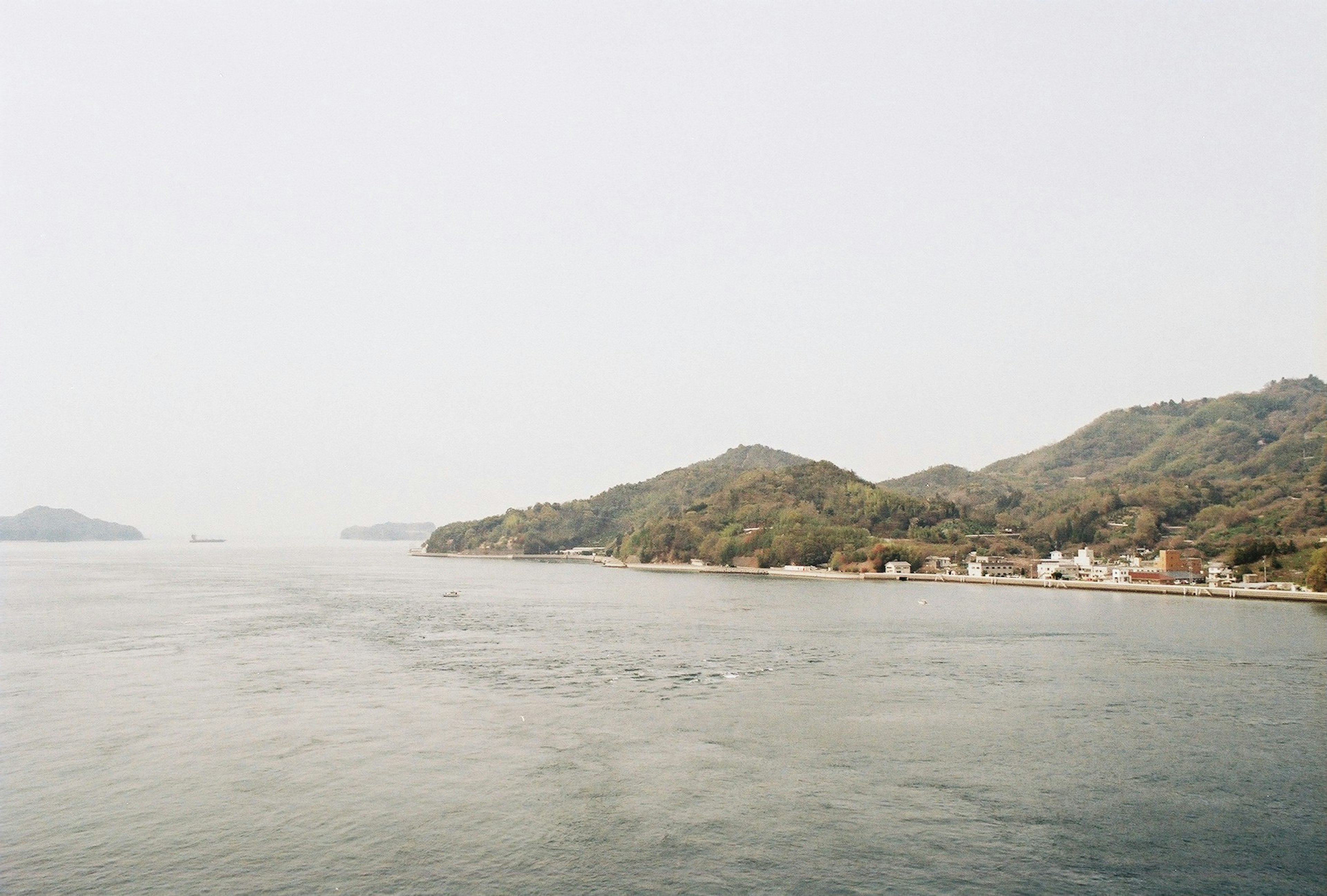 Serene village along a coastal landscape with hills