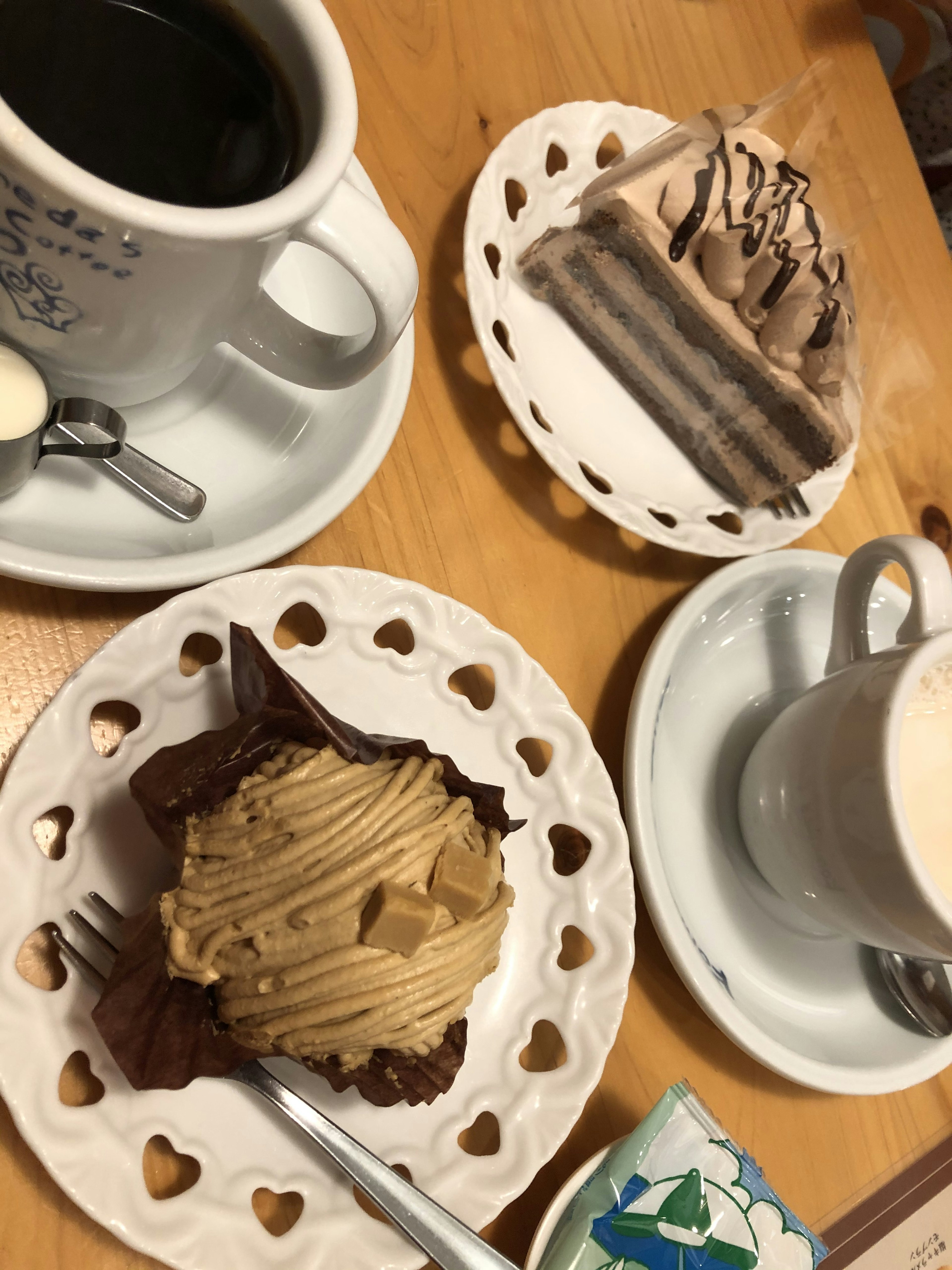 A table set with coffee and a variety of cakes