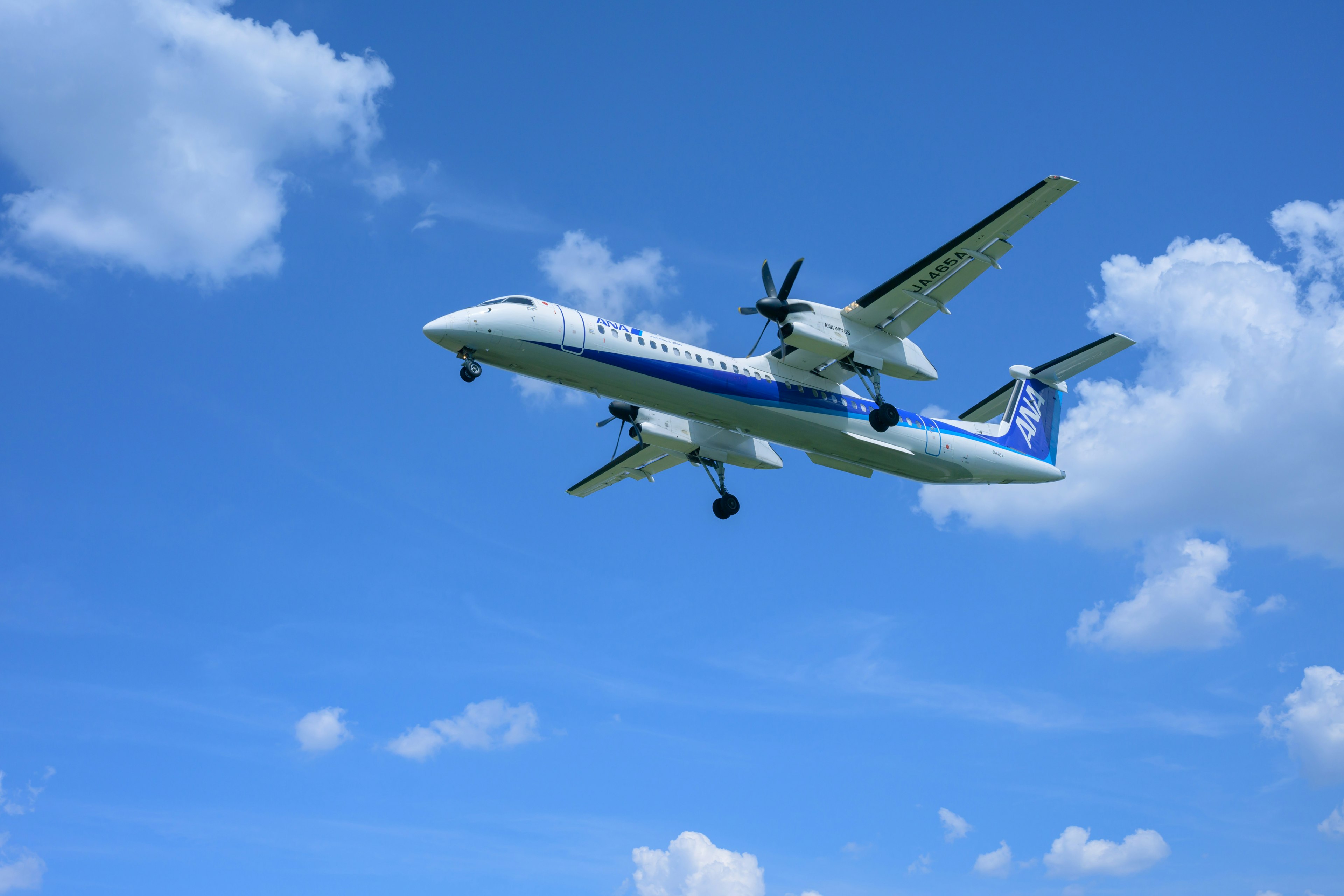 Propeller aircraft flying under a blue sky