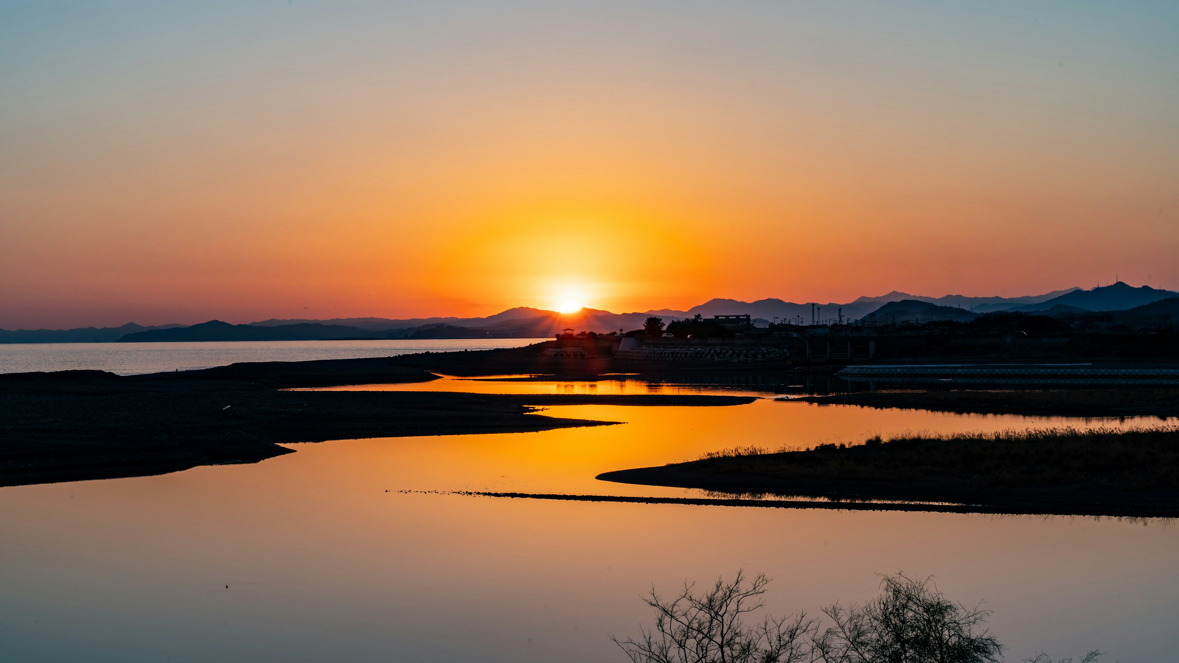 Scenic view of a coastline at sunset with vibrant colors