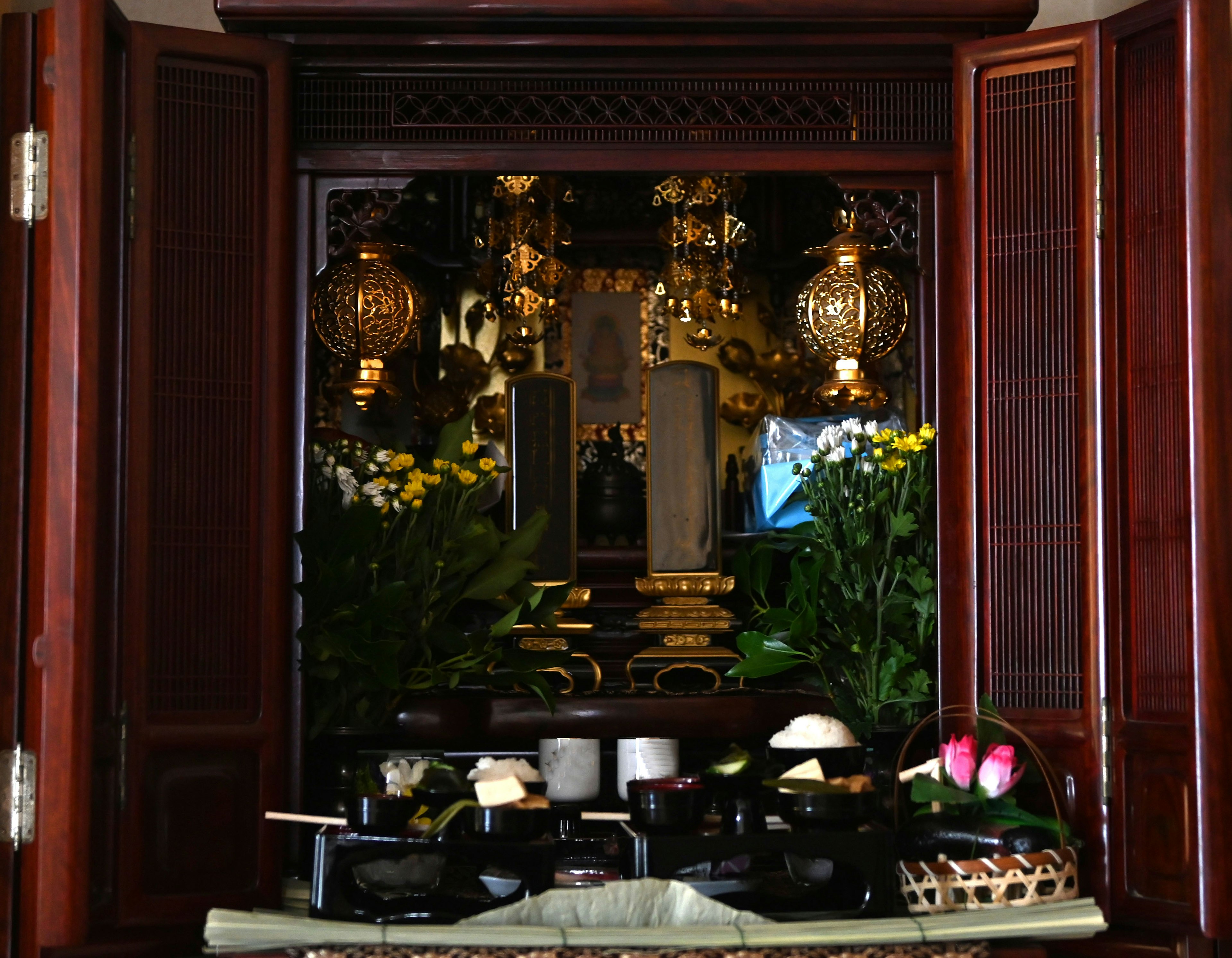 Beautifully arranged food and flowers on a wooden altar