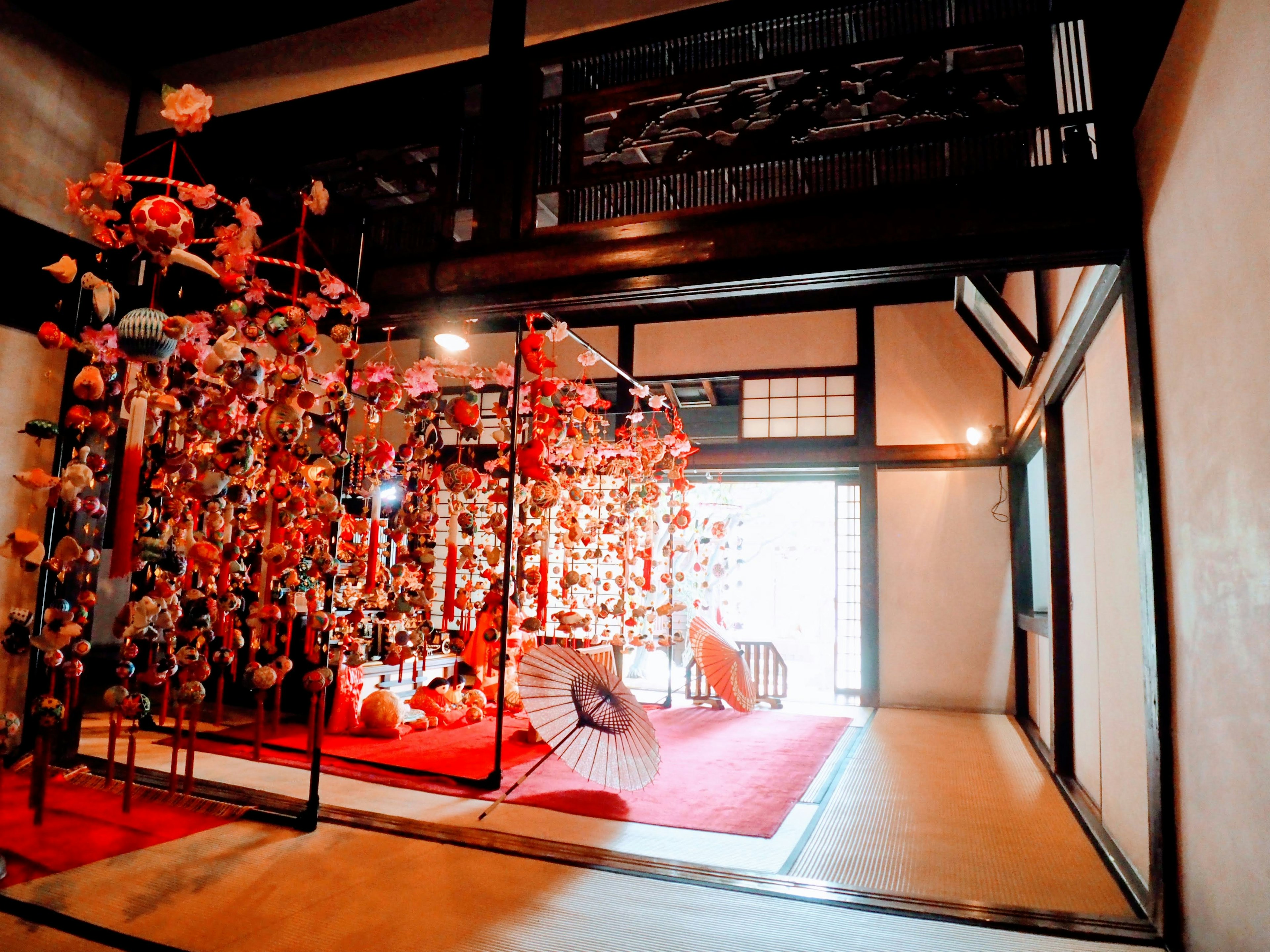 Traditional Japanese room featuring colorful decorations and a red carpet