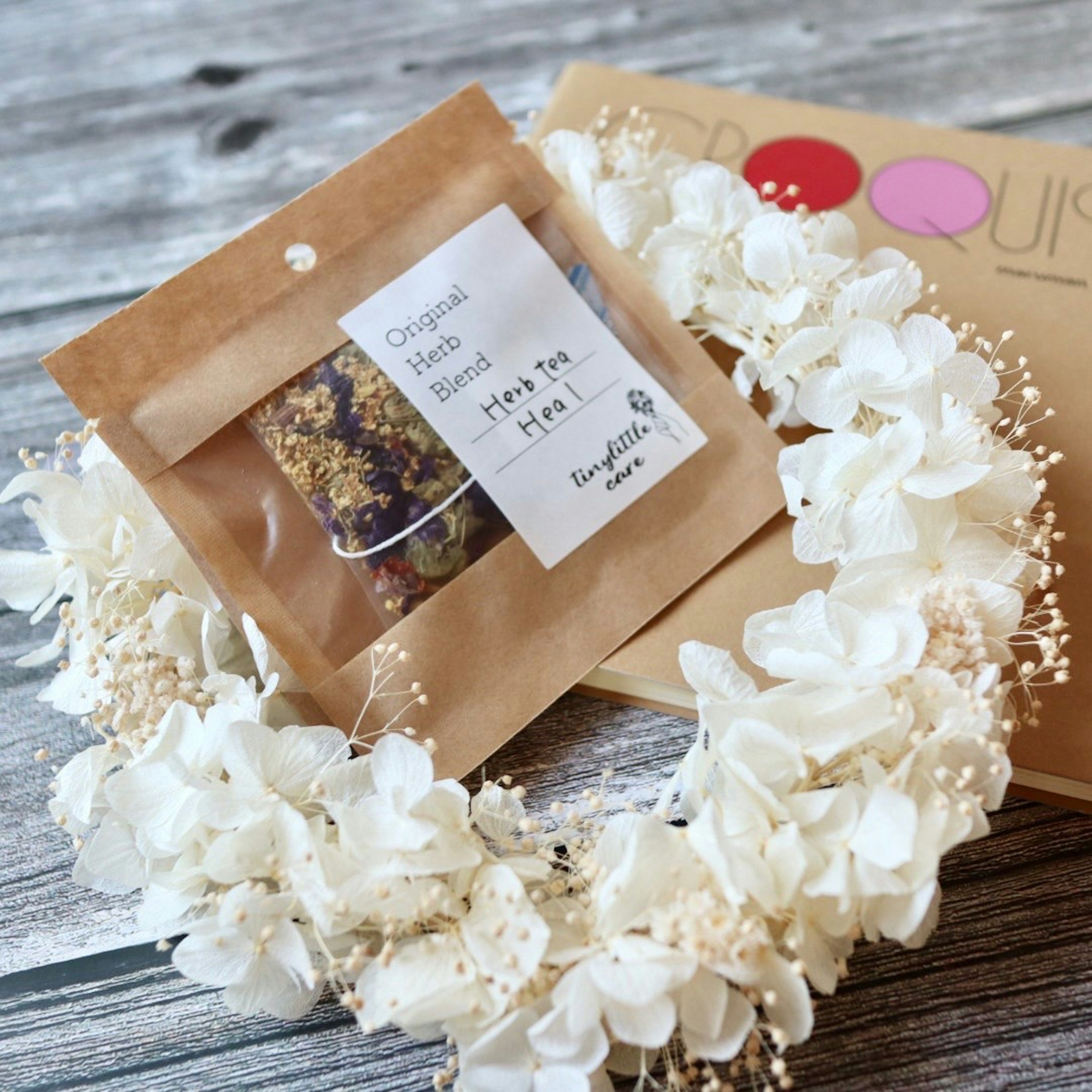 White floral wreath with a packaged treat