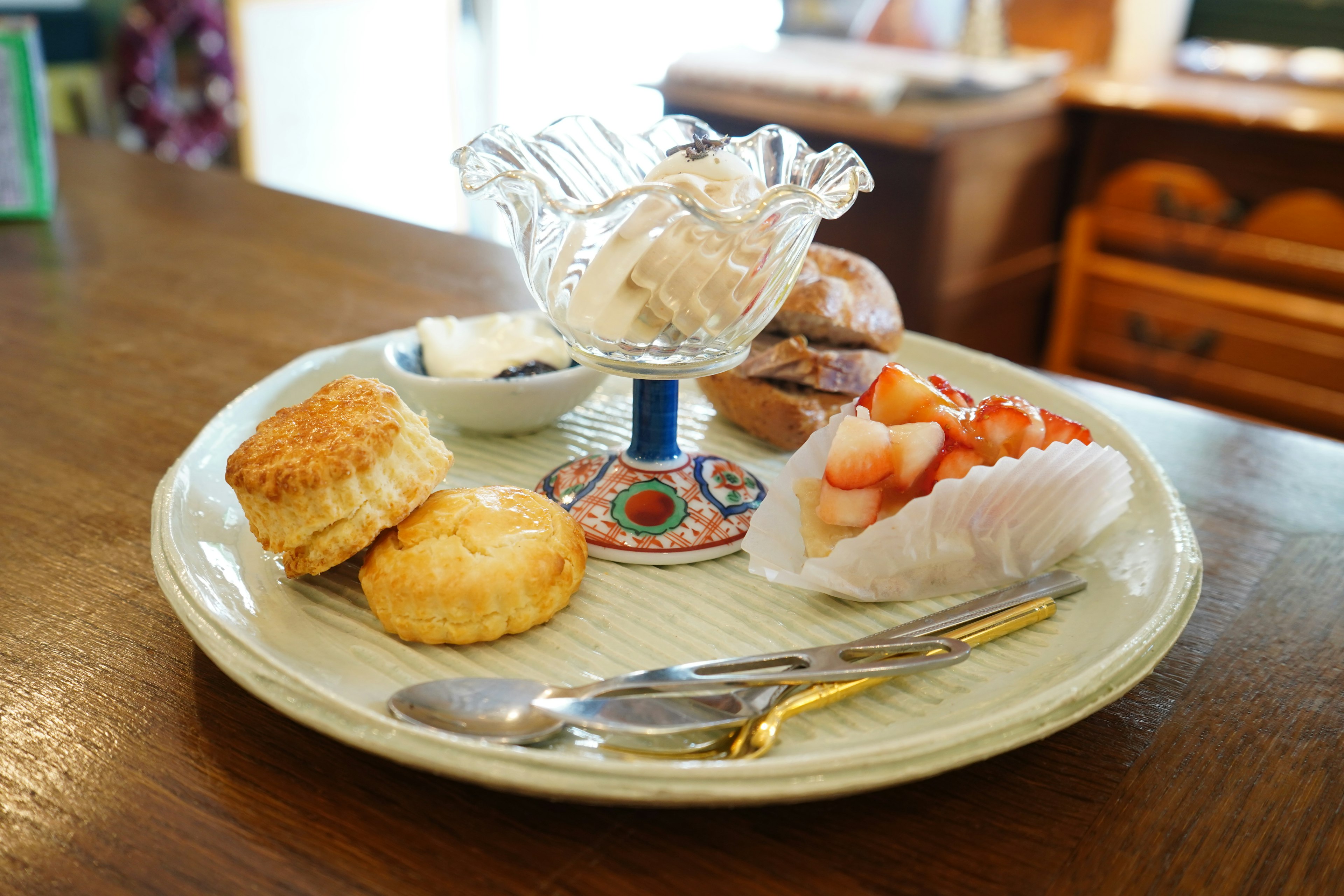 A platter of desserts featuring ice cream and fresh fruit on a decorative dish