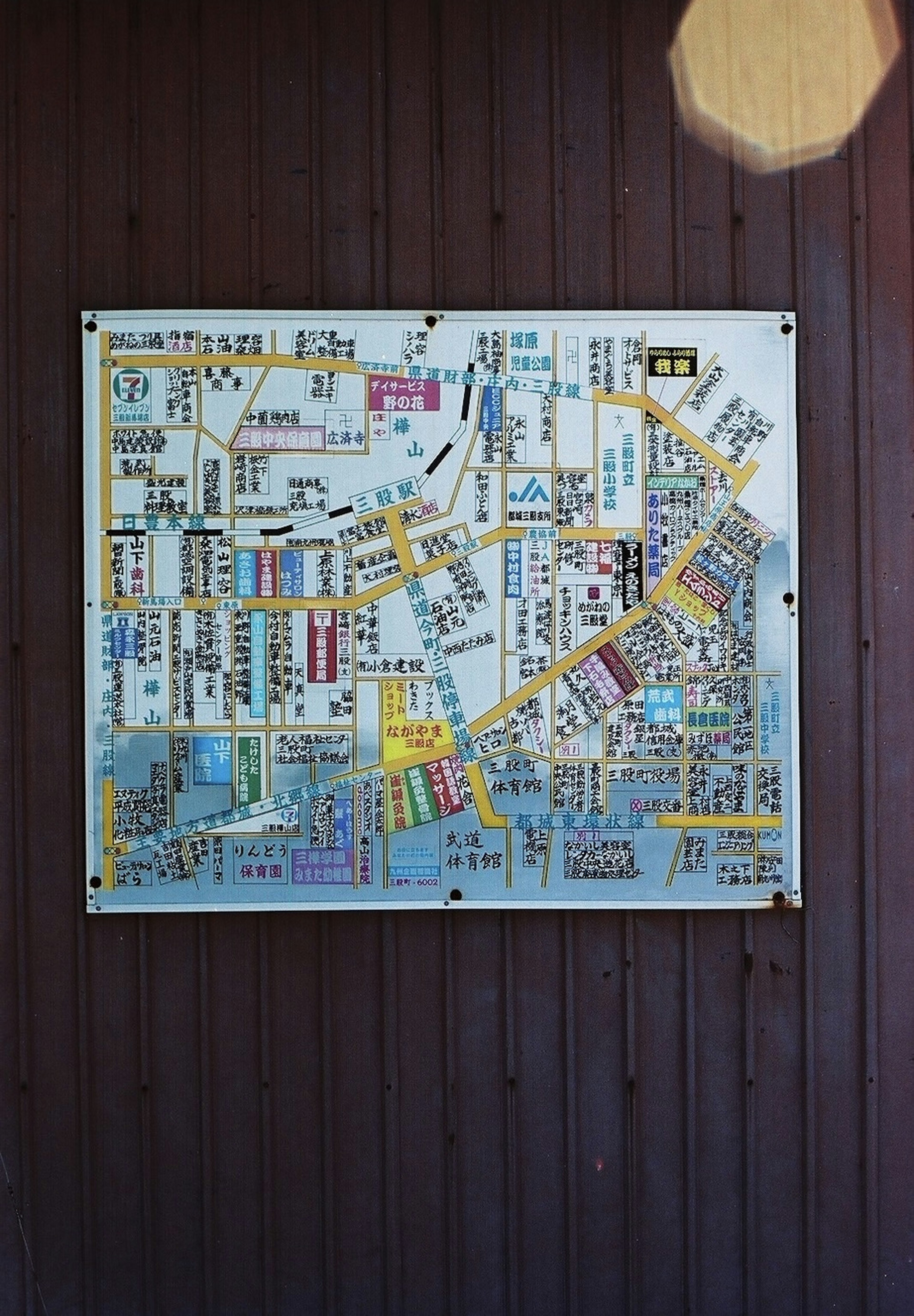 A map board mounted on a wooden wall