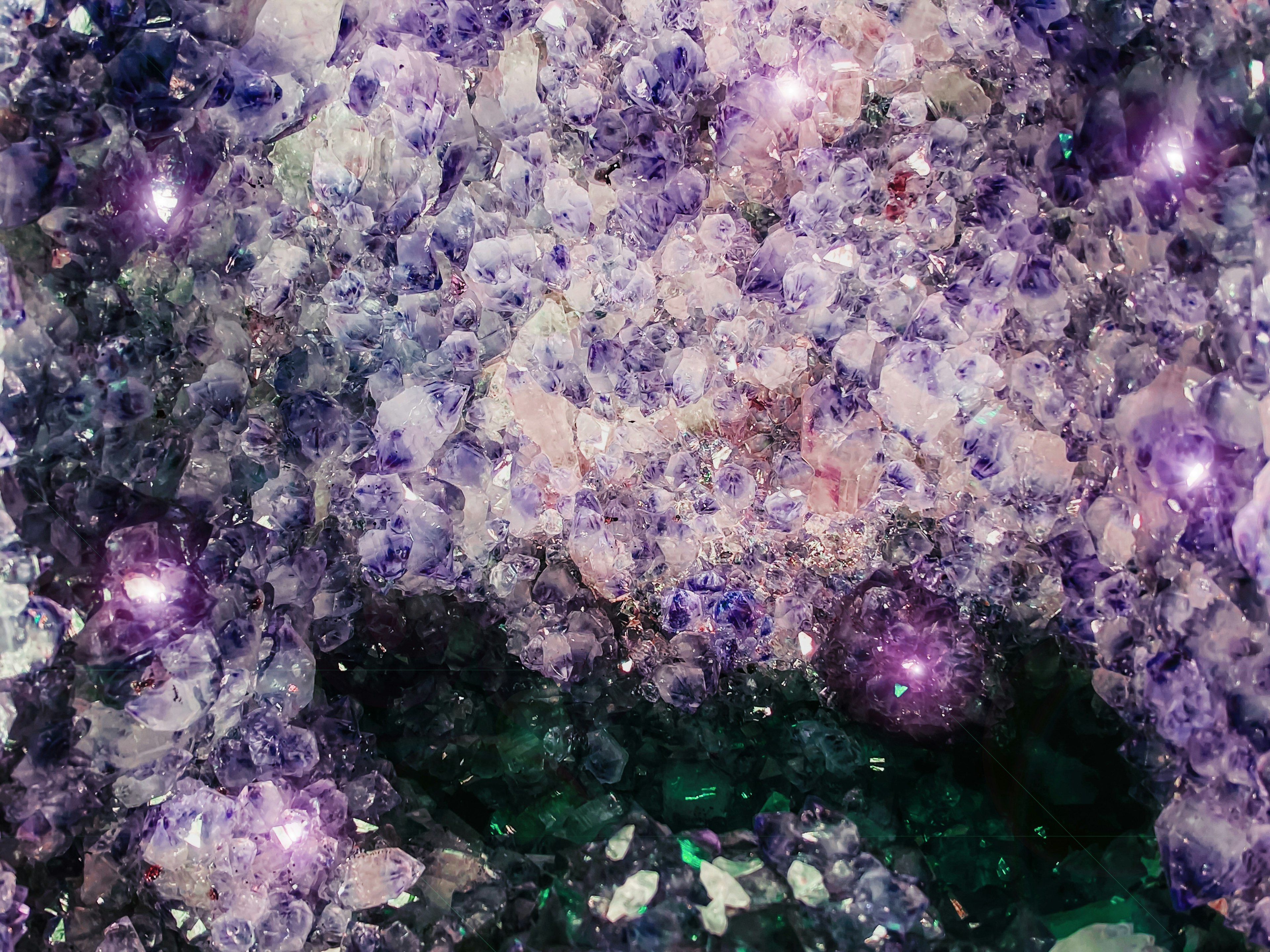 Close-up of beautiful crystals featuring purple amethyst and green gemstones