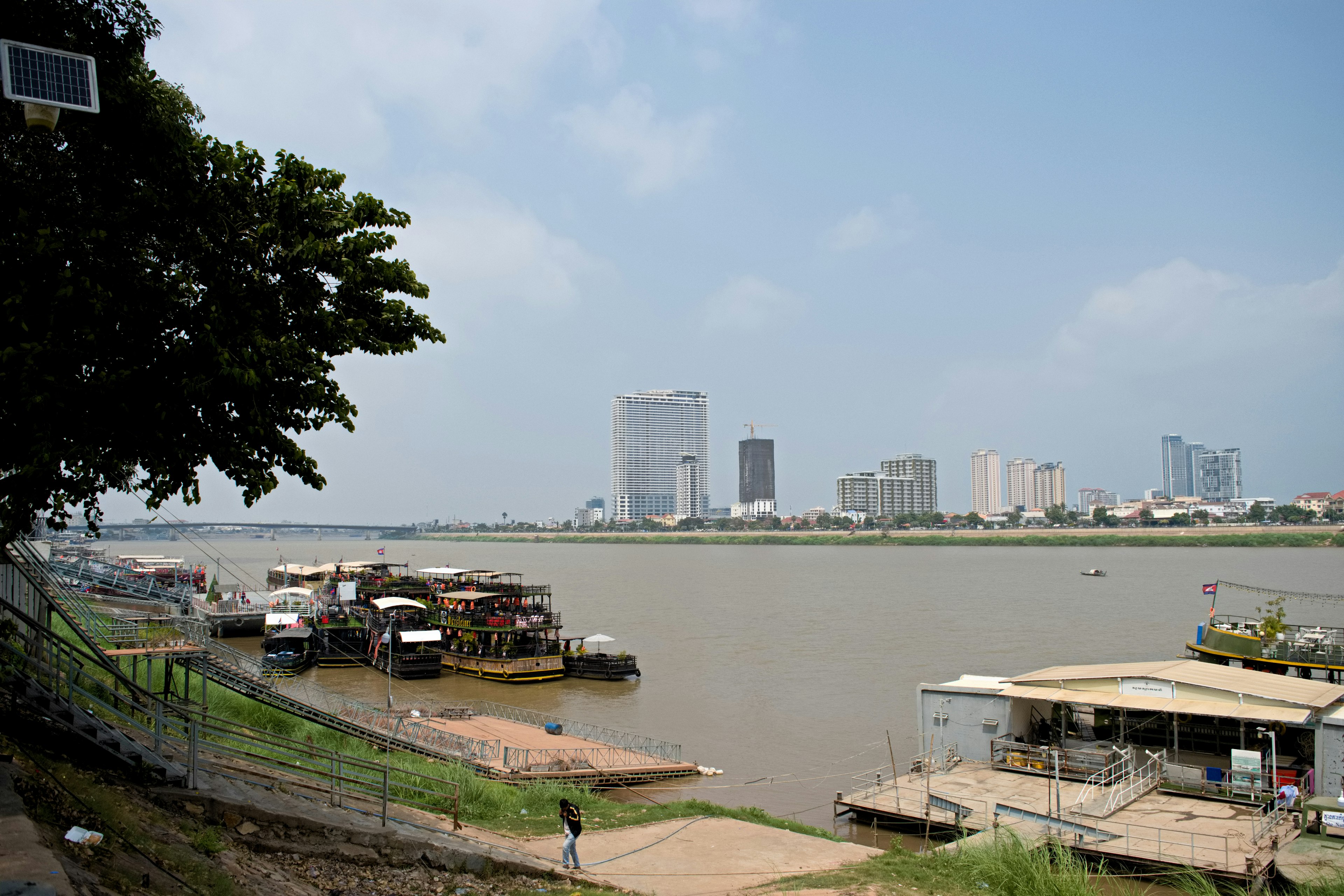 Cityscape along the riverbank with boats