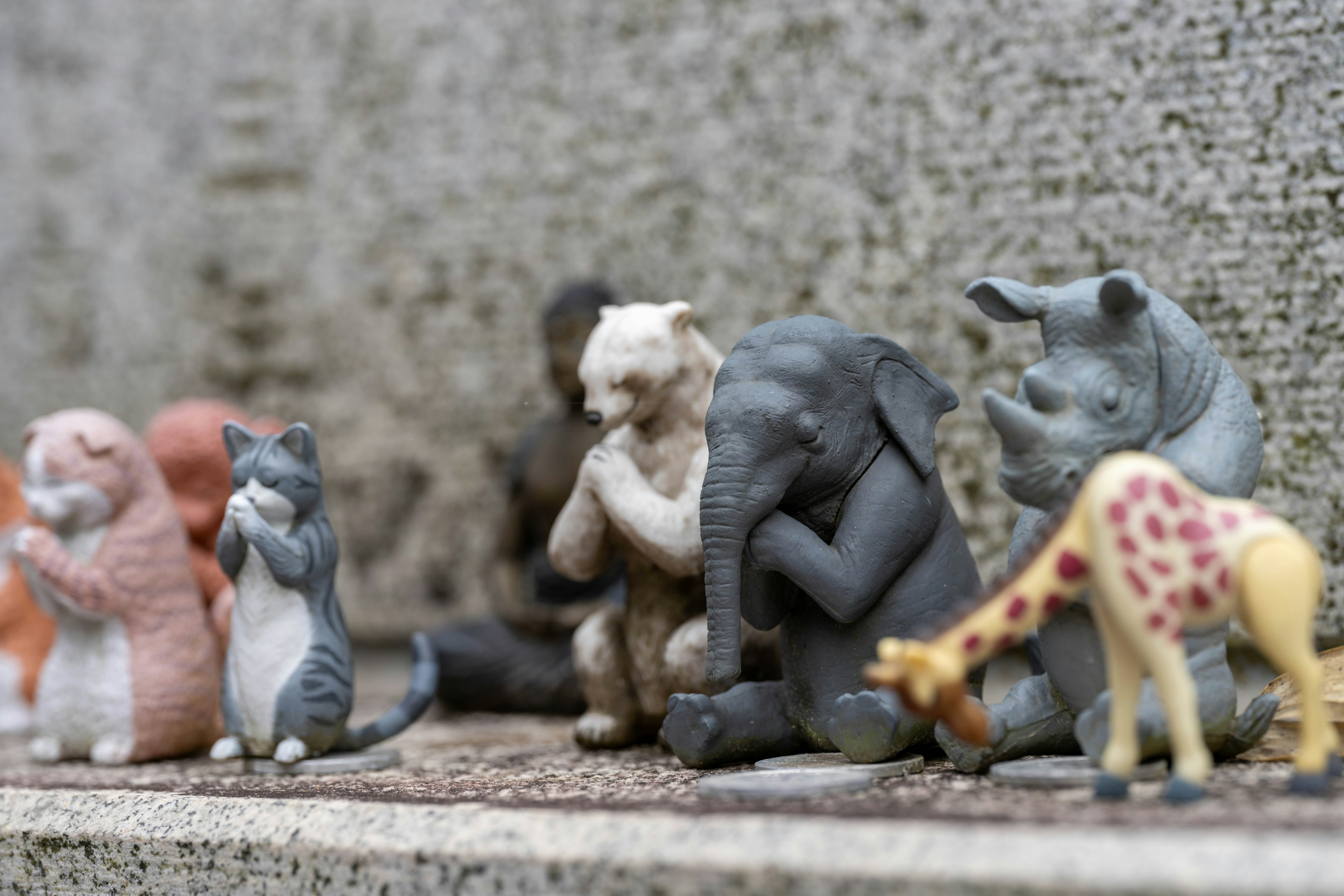 Small figurines of various animals lined up