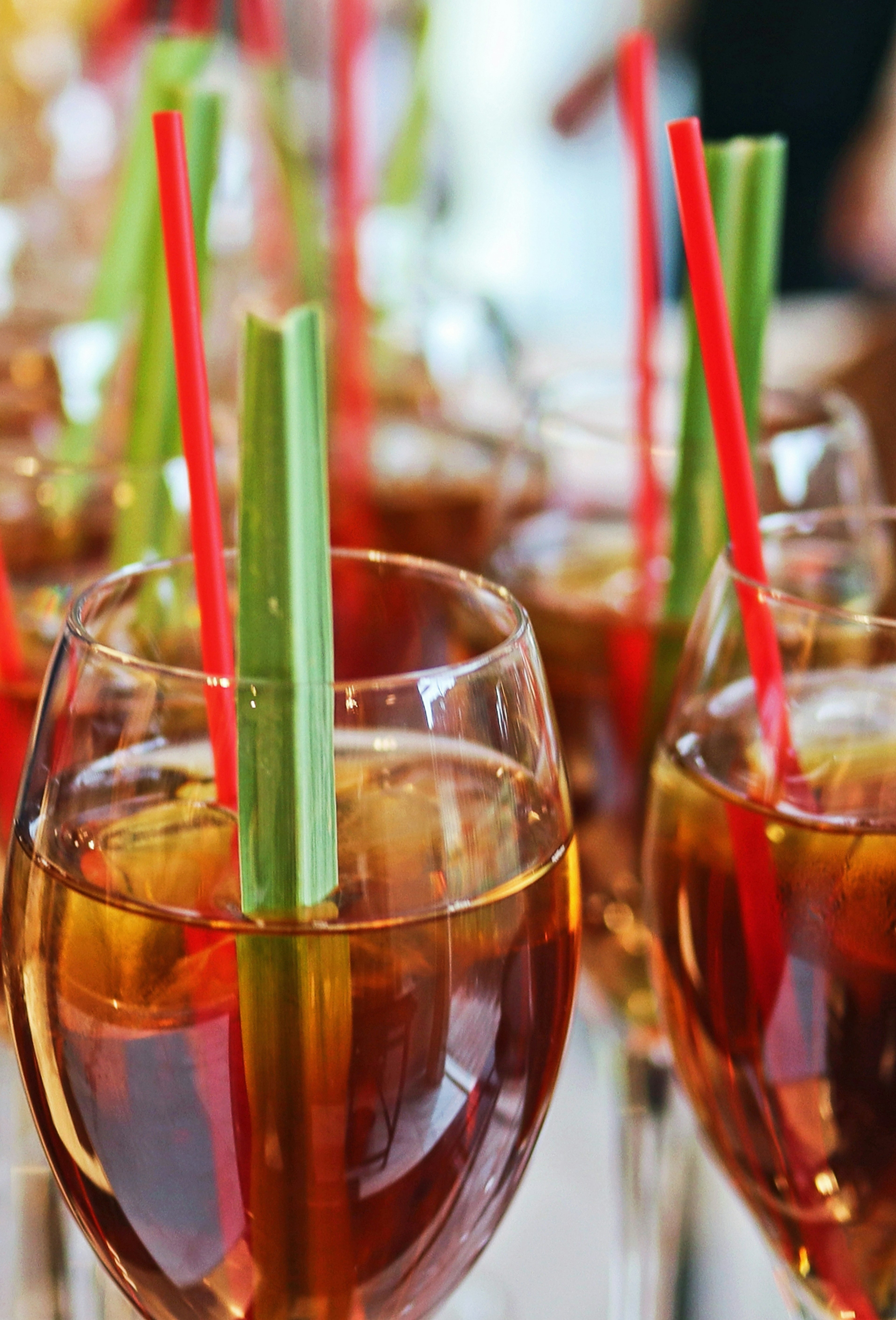 Glasses of drinks with colorful straws inserted