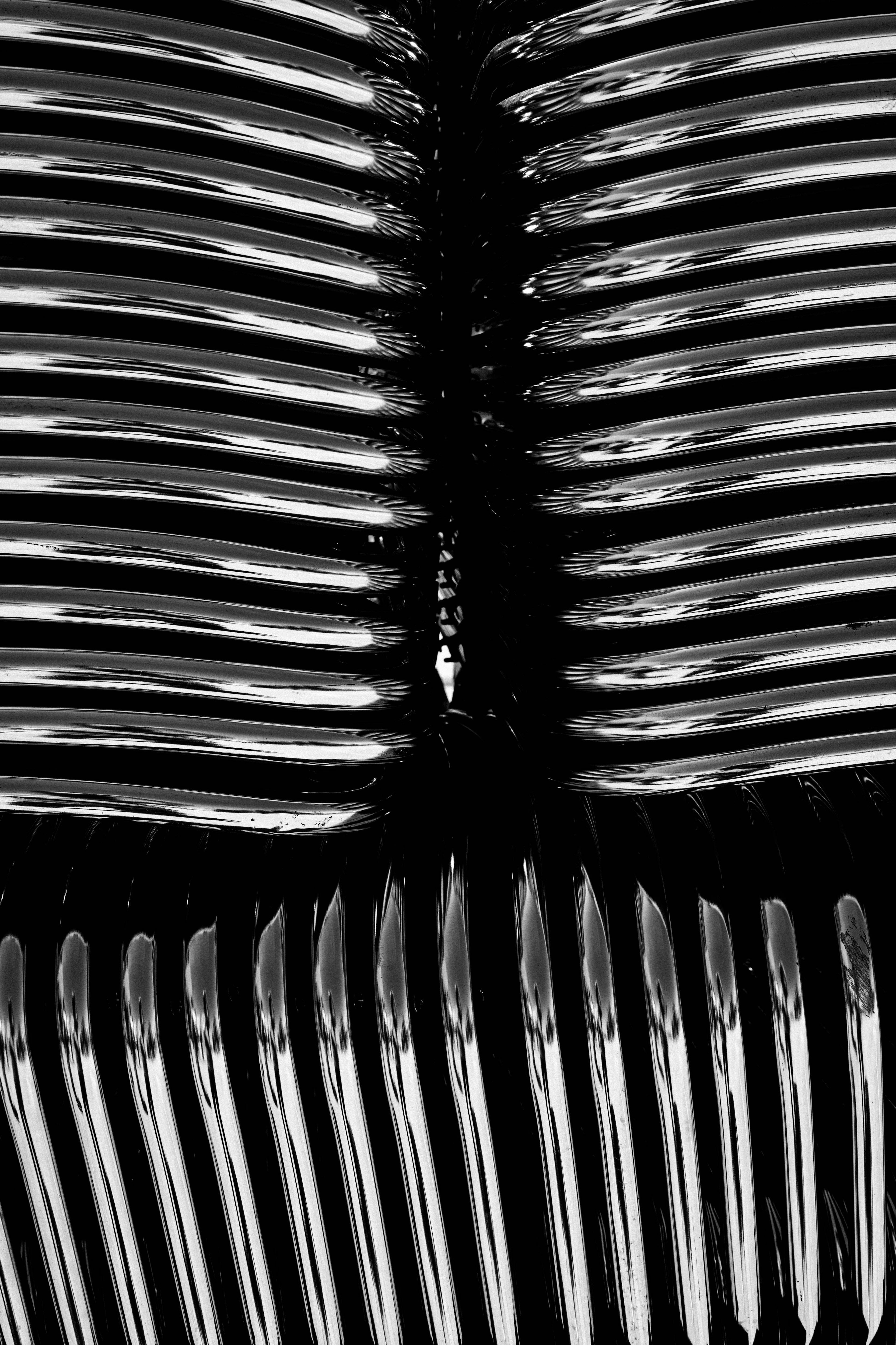 Close-up of metallic combs arranged against a black background