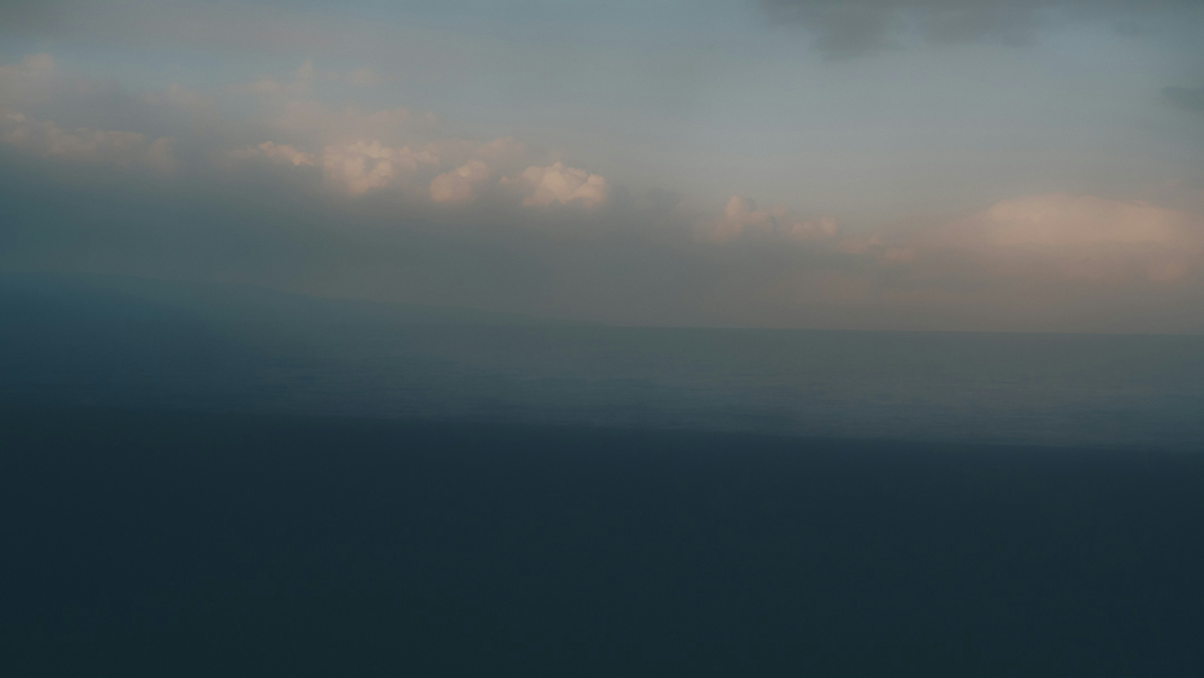 A serene landscape of ocean and sky at twilight