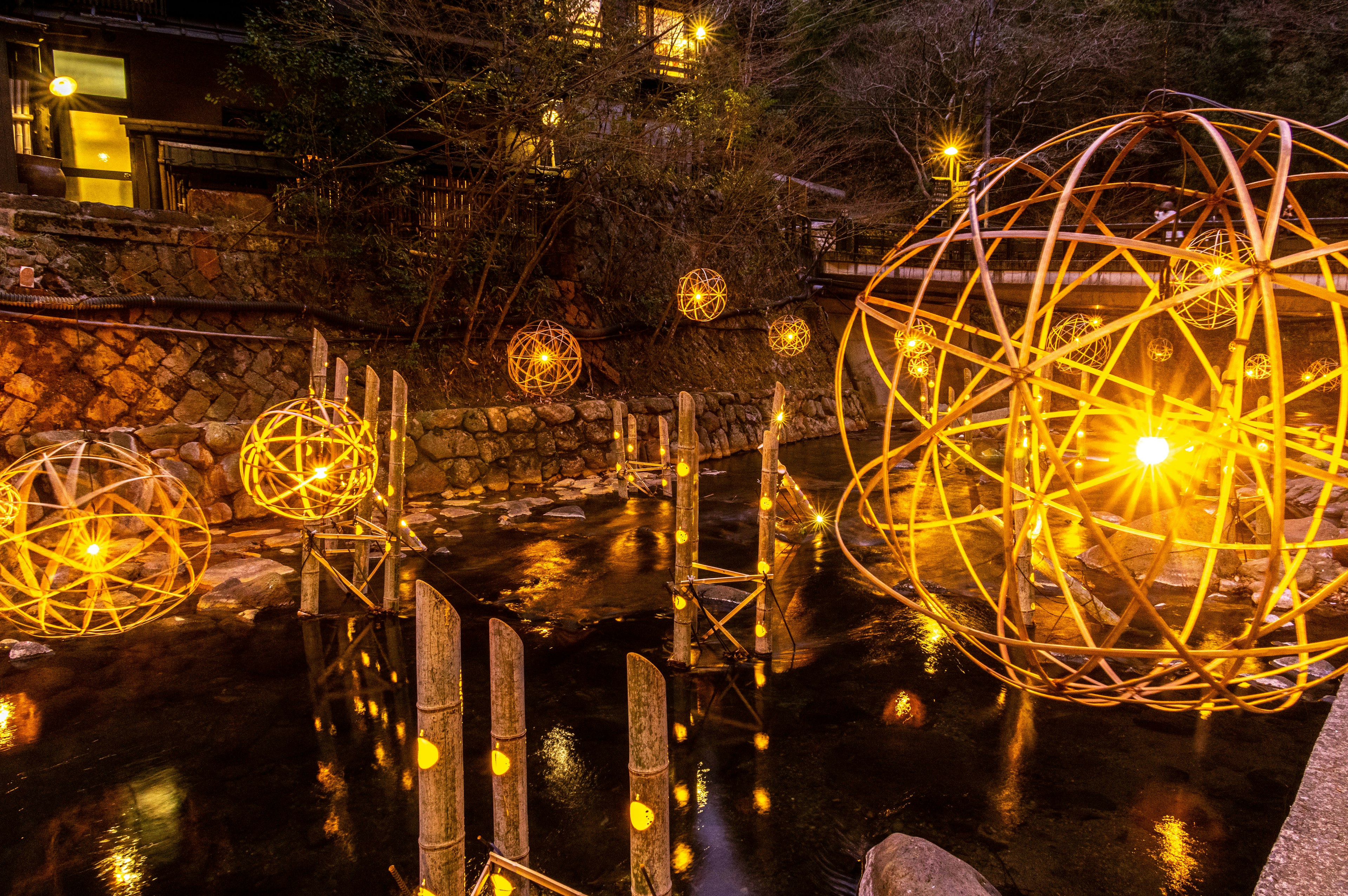 Scenic view with beautiful illuminated spheres floating on water