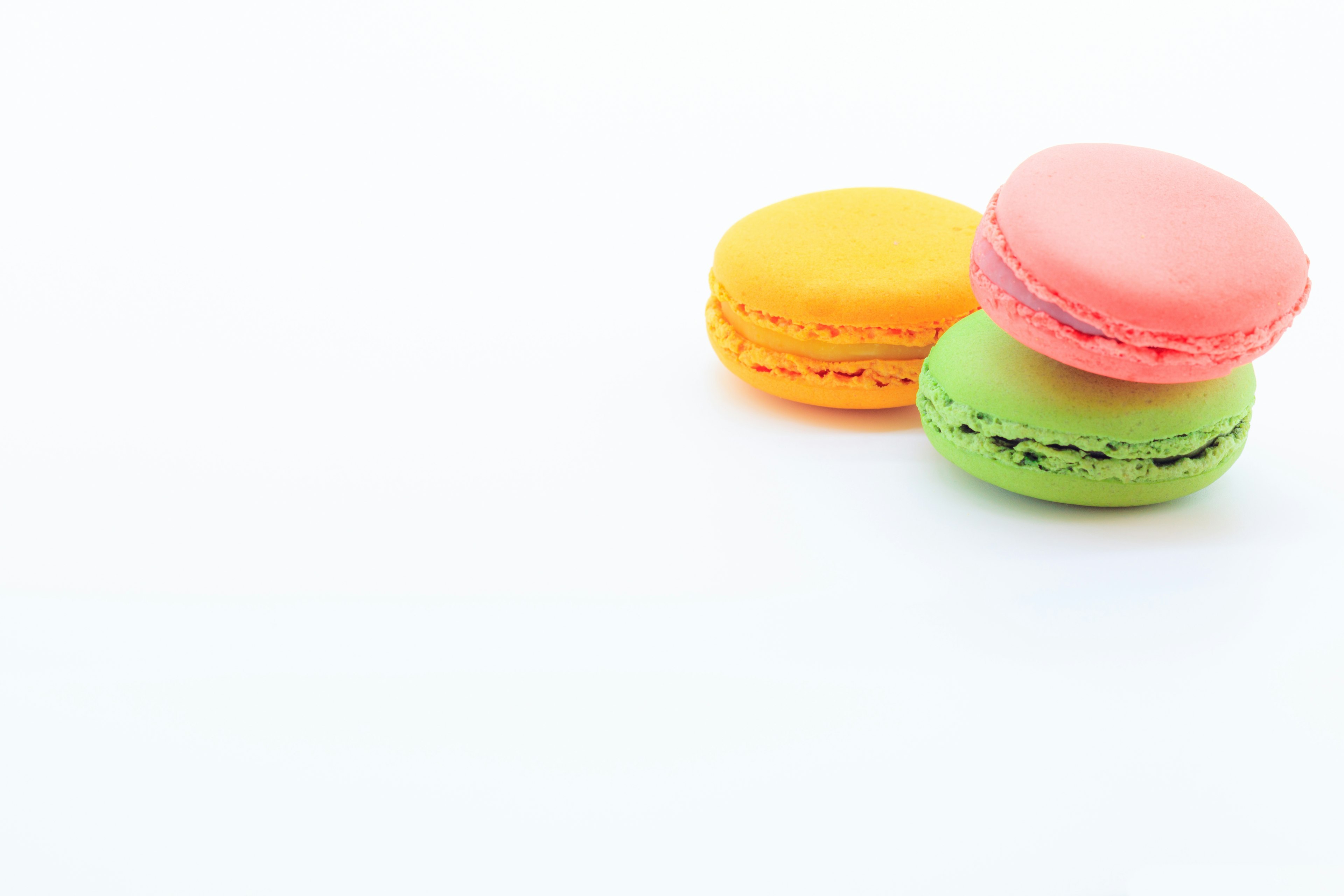 Colorful macarons displayed on a white background