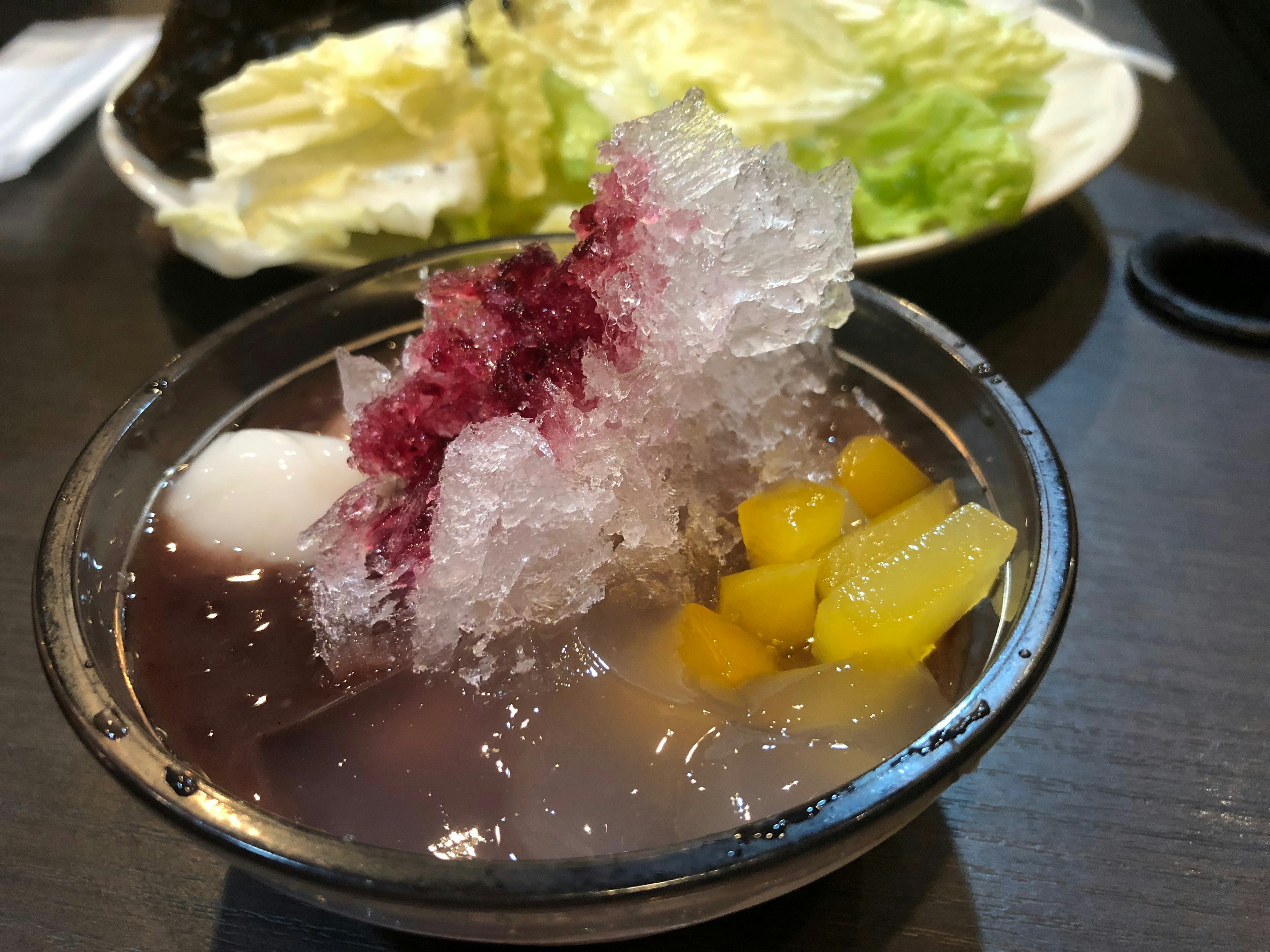 Dessert featuring shaved ice with fruits and sweet toppings