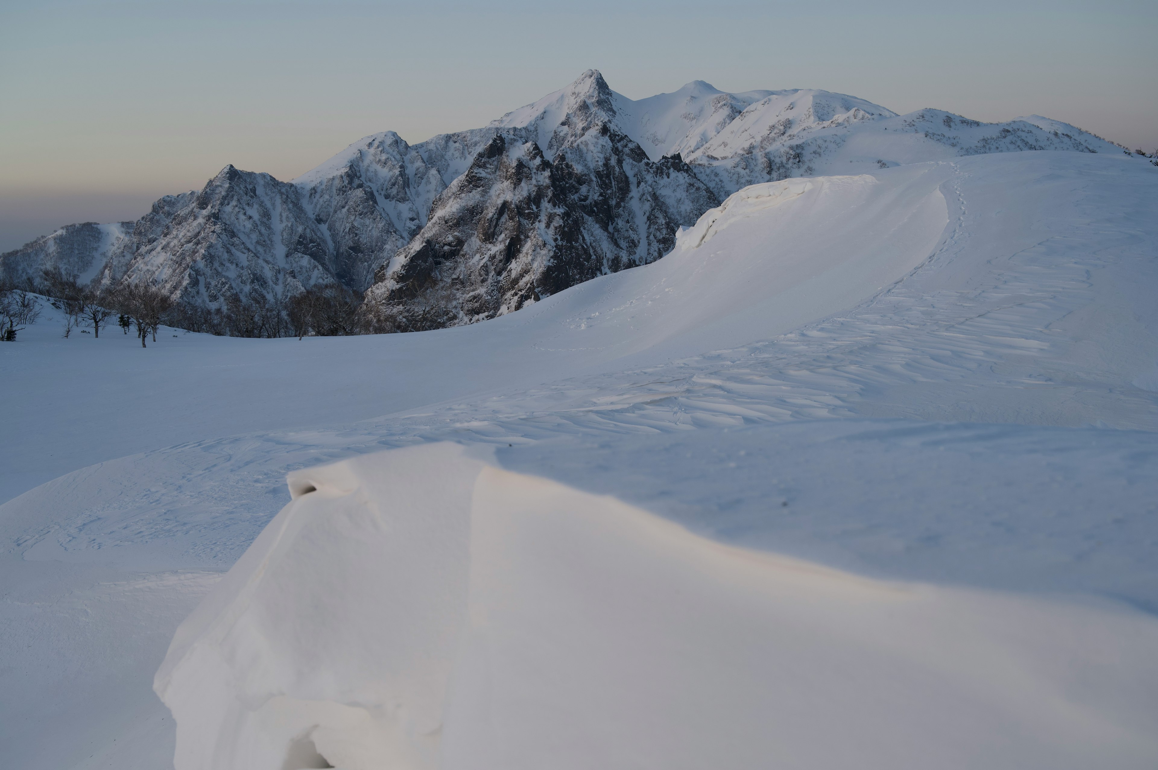 Snow-covered mountain landscape with blue sky