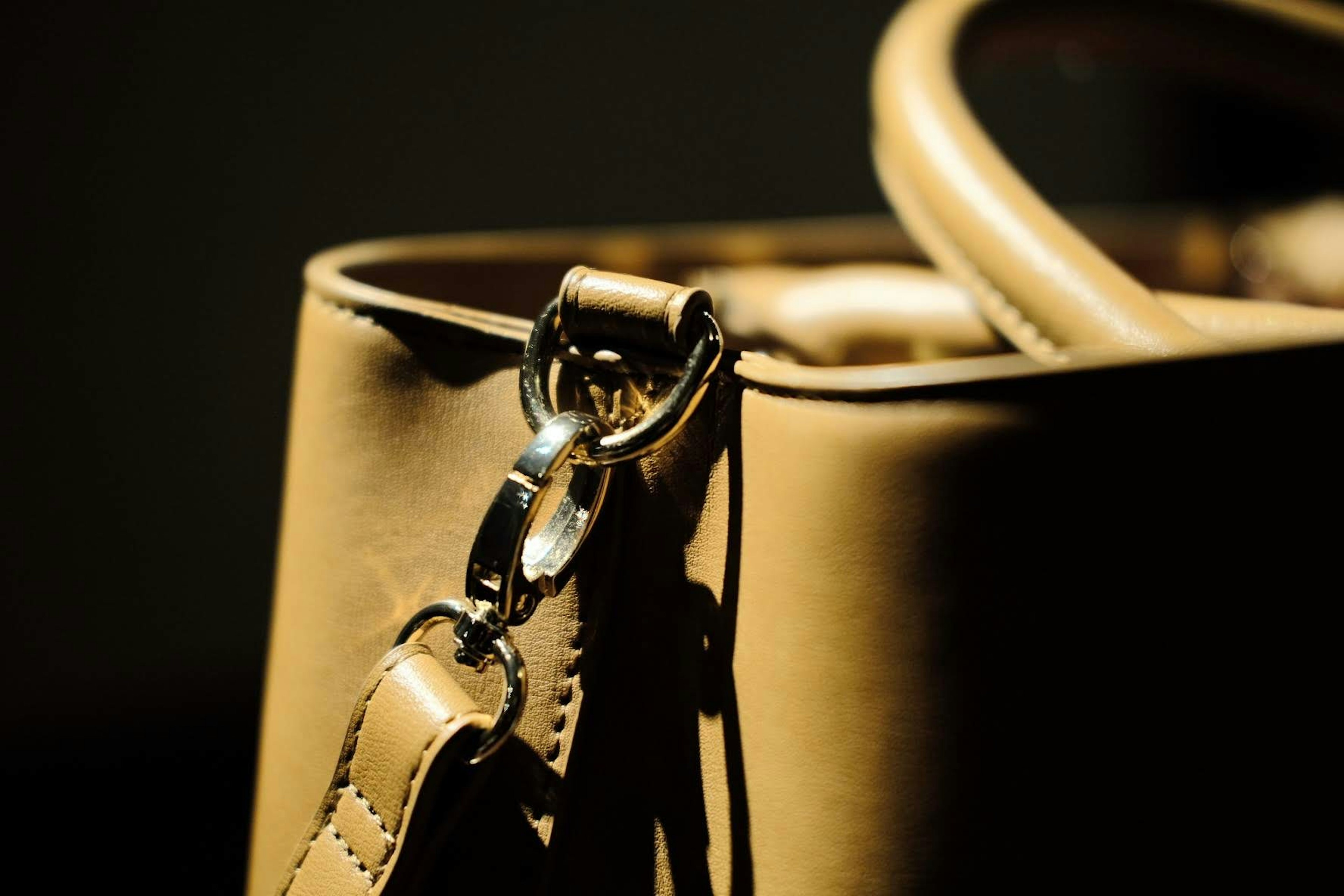 Close-up of a leather handbag with metal hardware