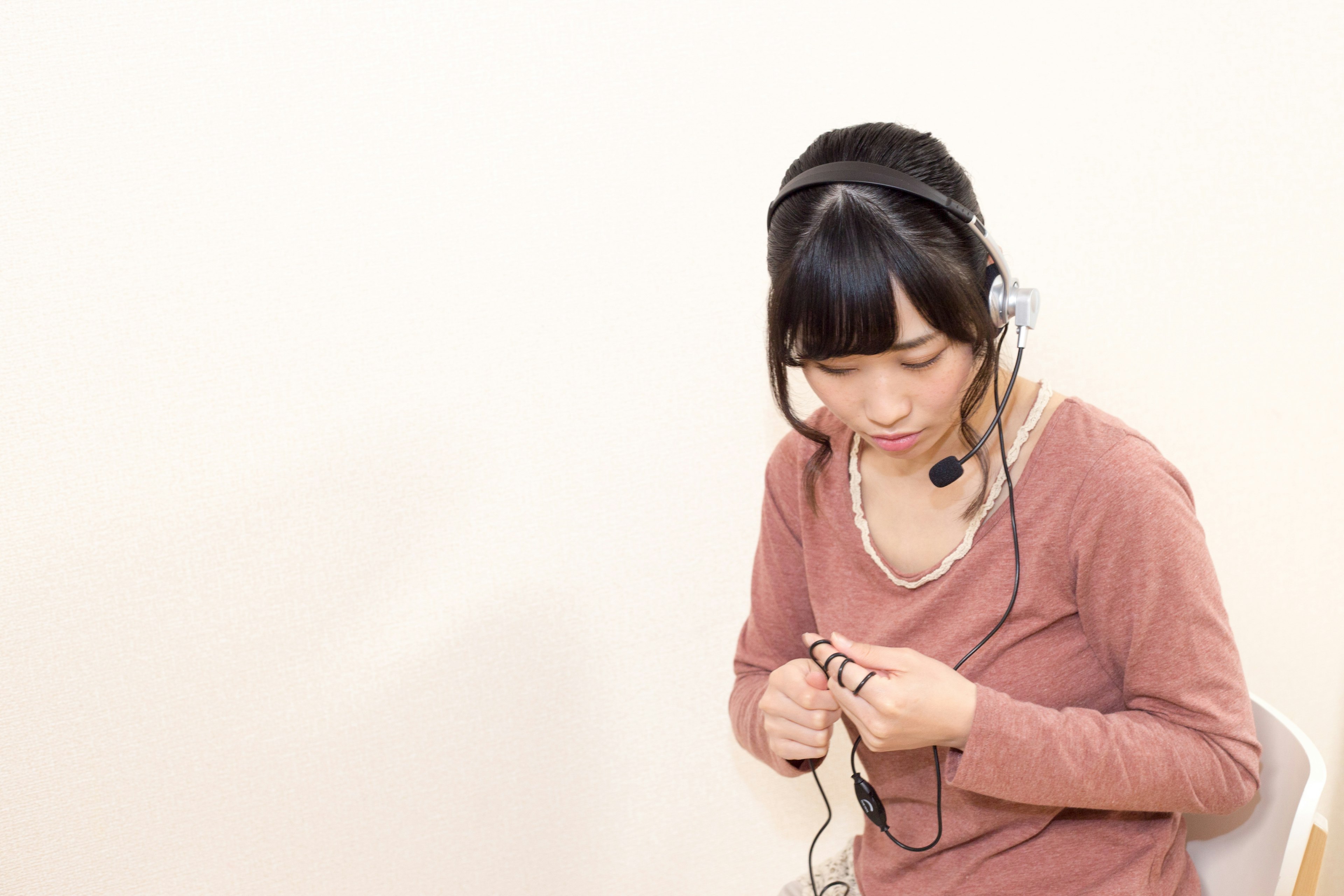 A woman wearing a headset organizing cables