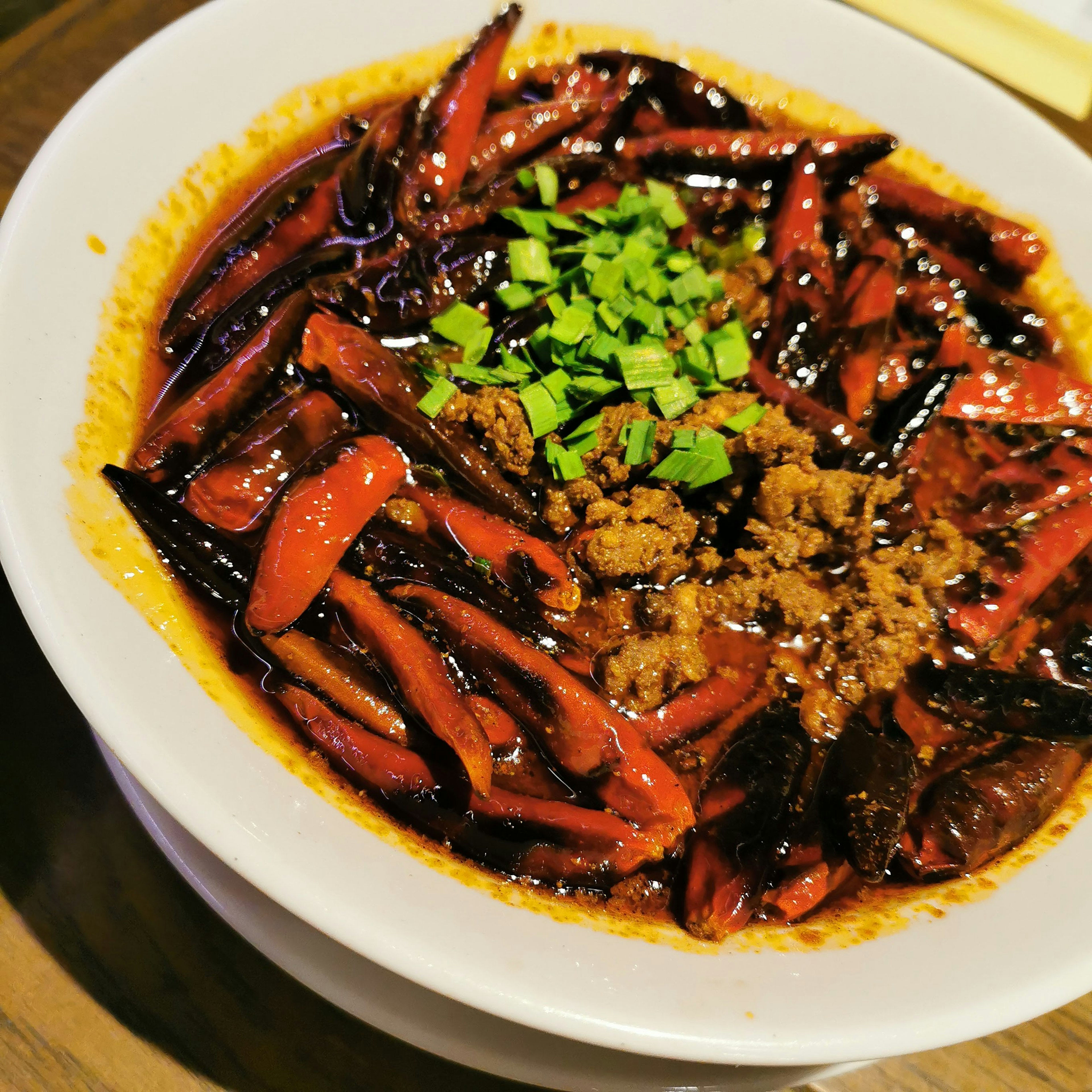 Delicious dish topped with spicy red peppers and chopped green onions