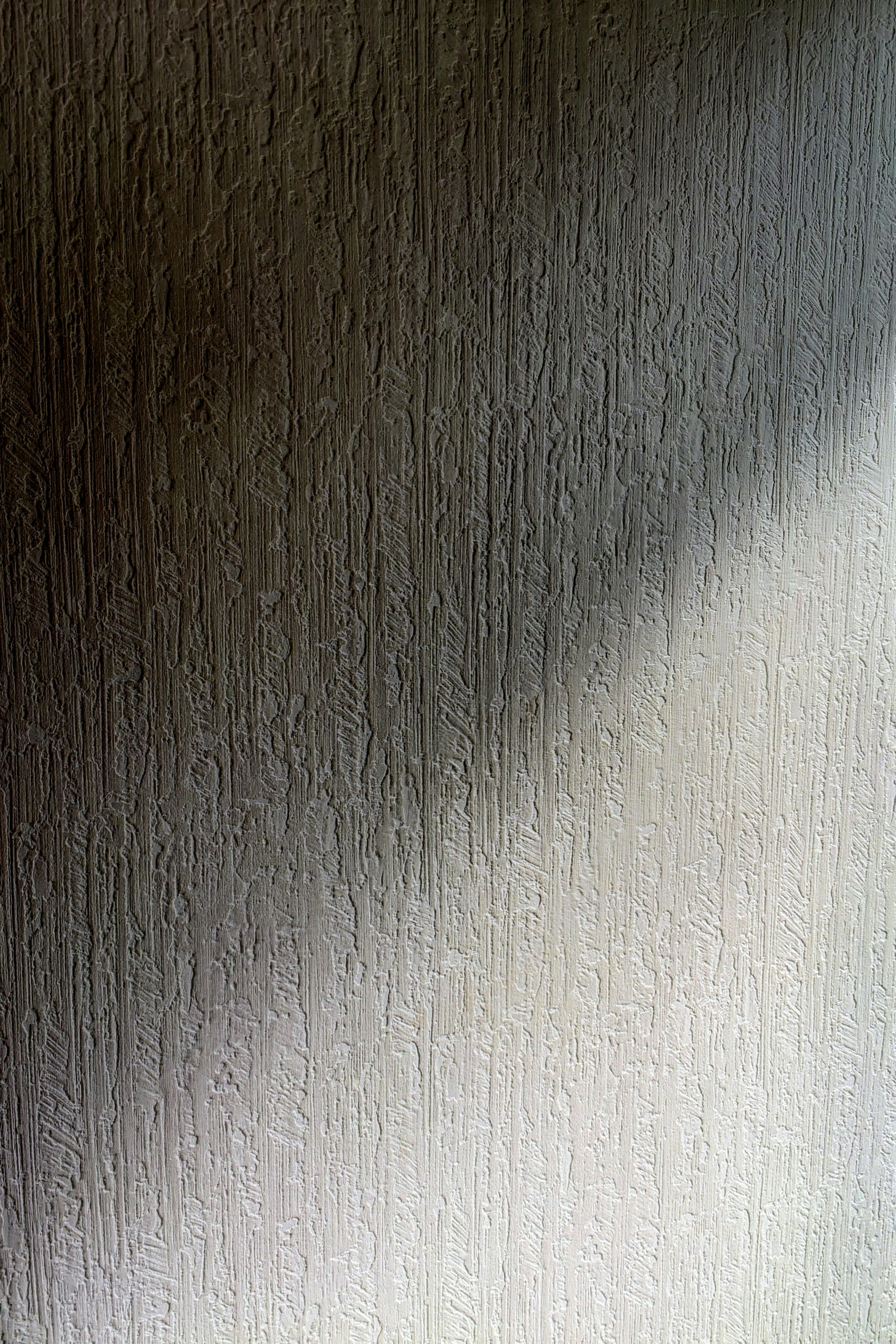 Textured light-colored surface with a shadow