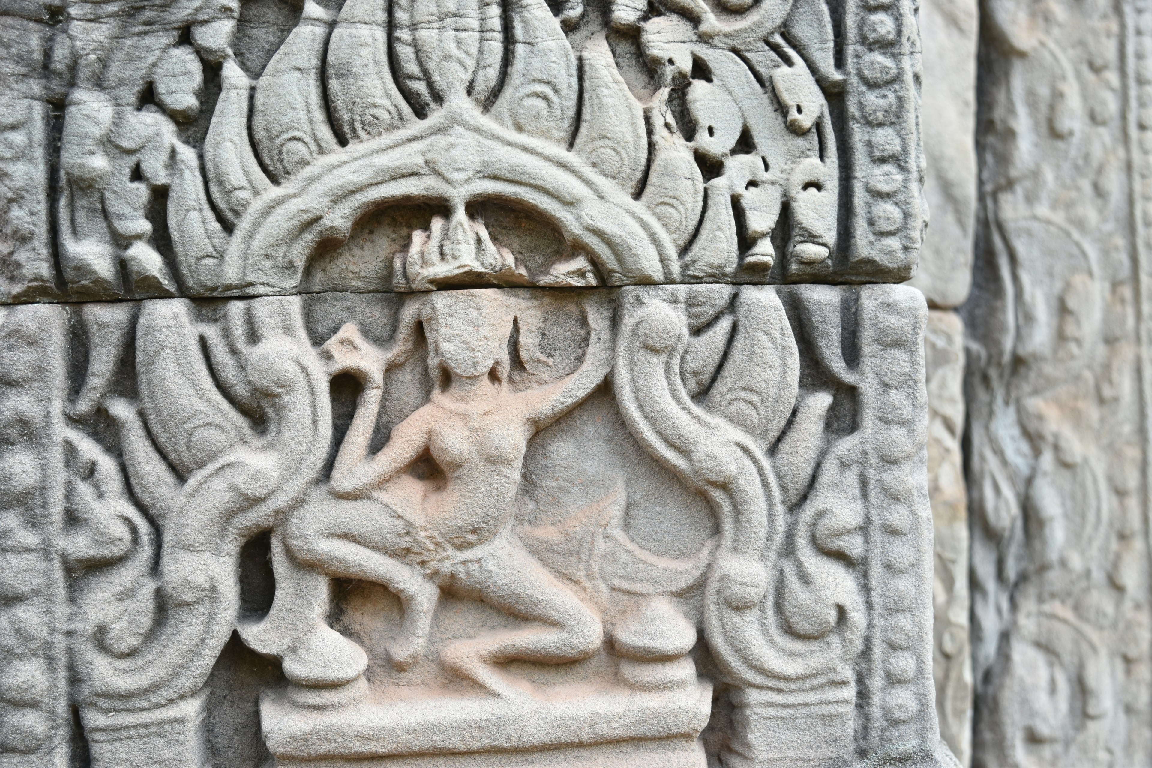 Intricate stone carving of a Hindu deity depicted on a wall