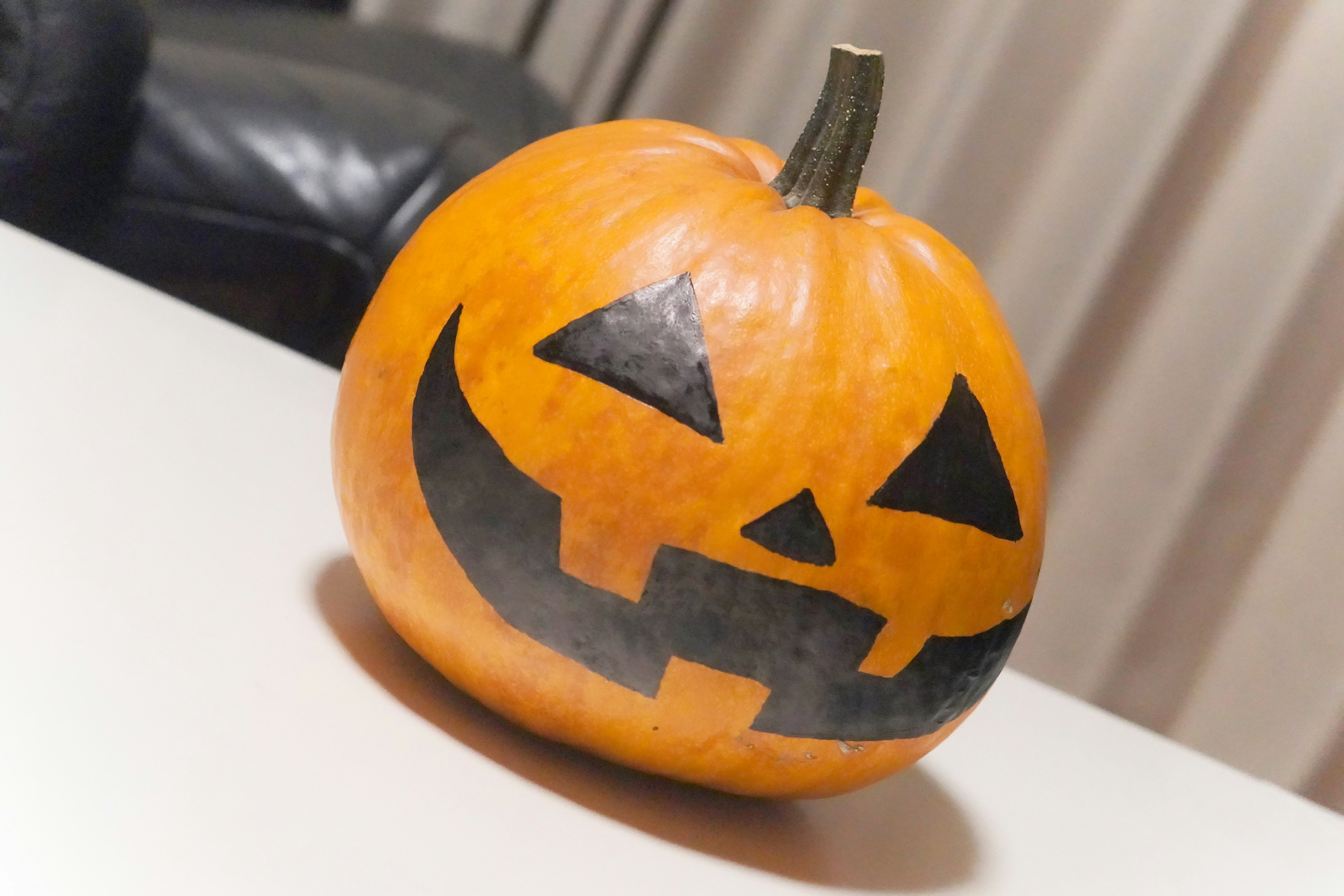 Orange jack-o'-lantern pumpkin with black face design