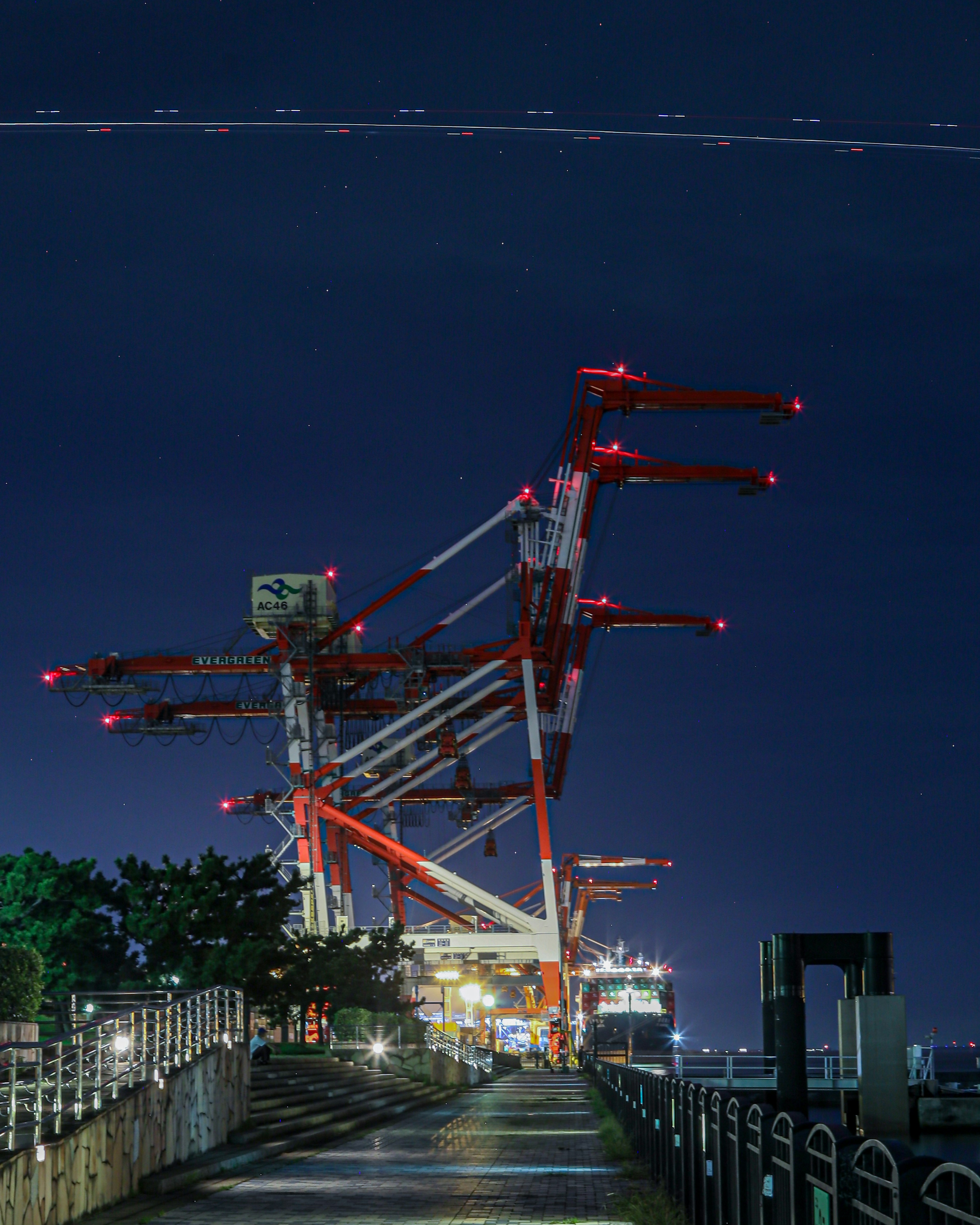 Night view of a red crane with a walkway