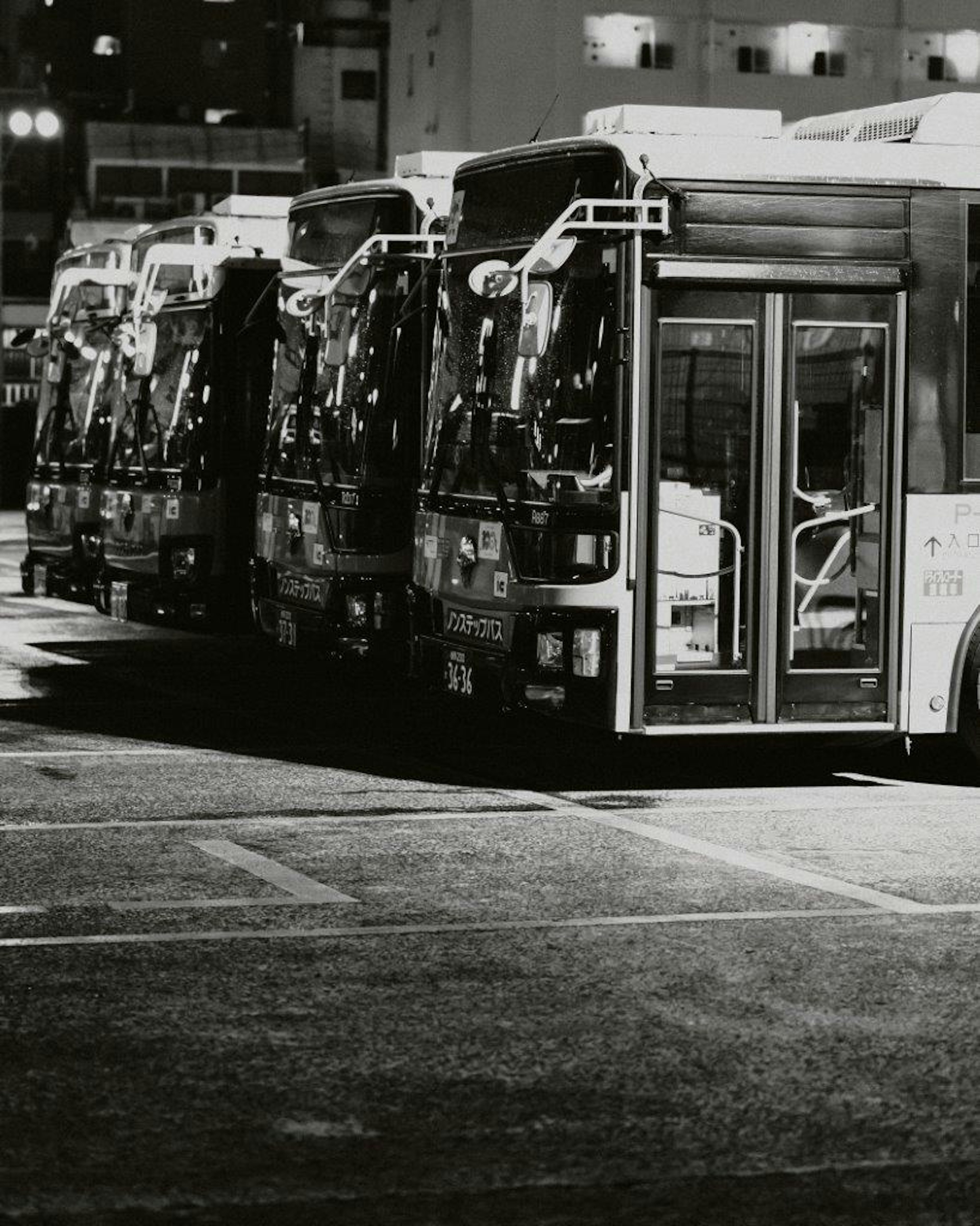 Row of buses parked at night