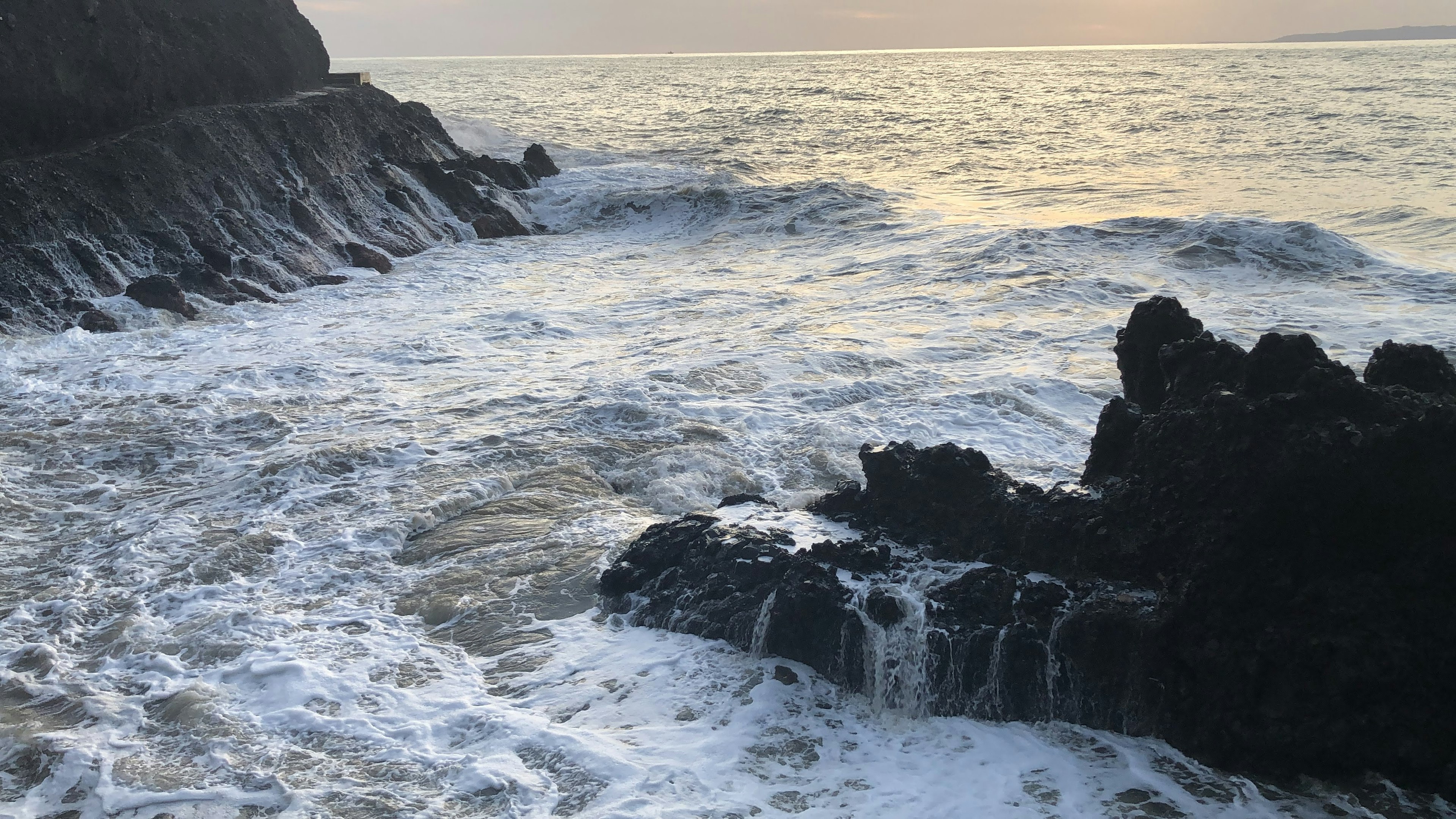 Coastal scene with waves crashing against rocks