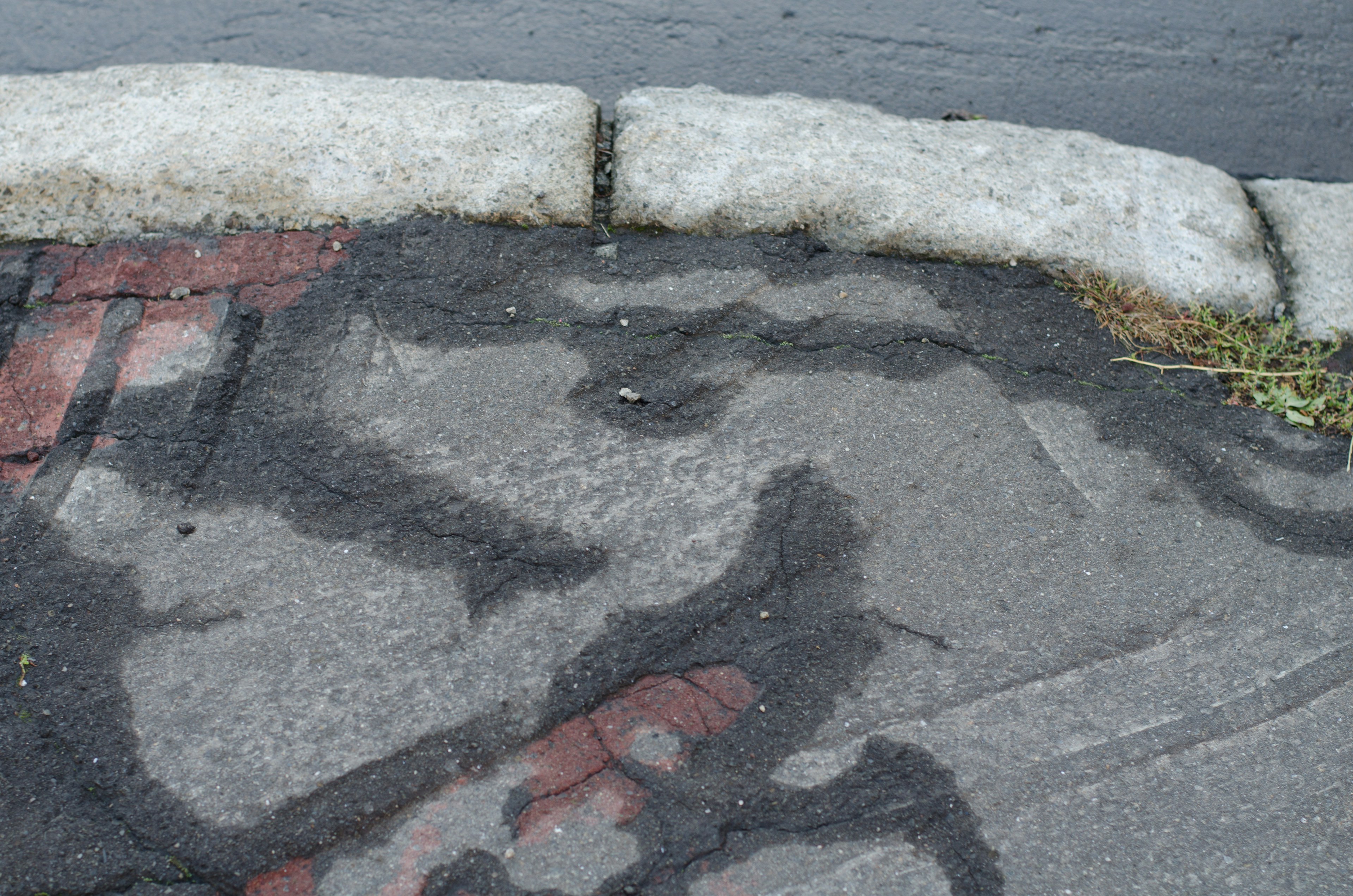 Abstract pattern on pavement with red lines