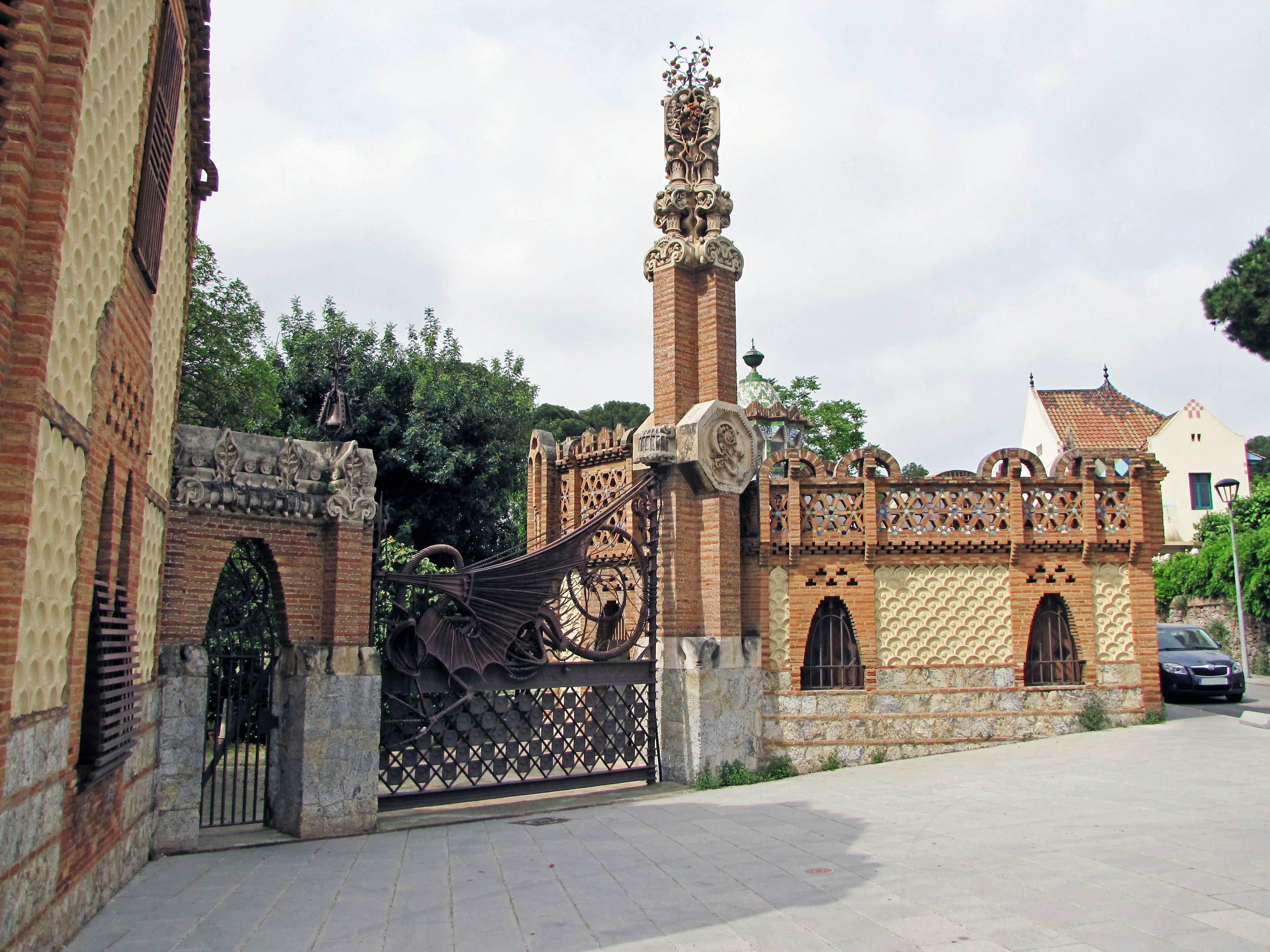 A decorative gate with unique architectural elements and surrounding buildings