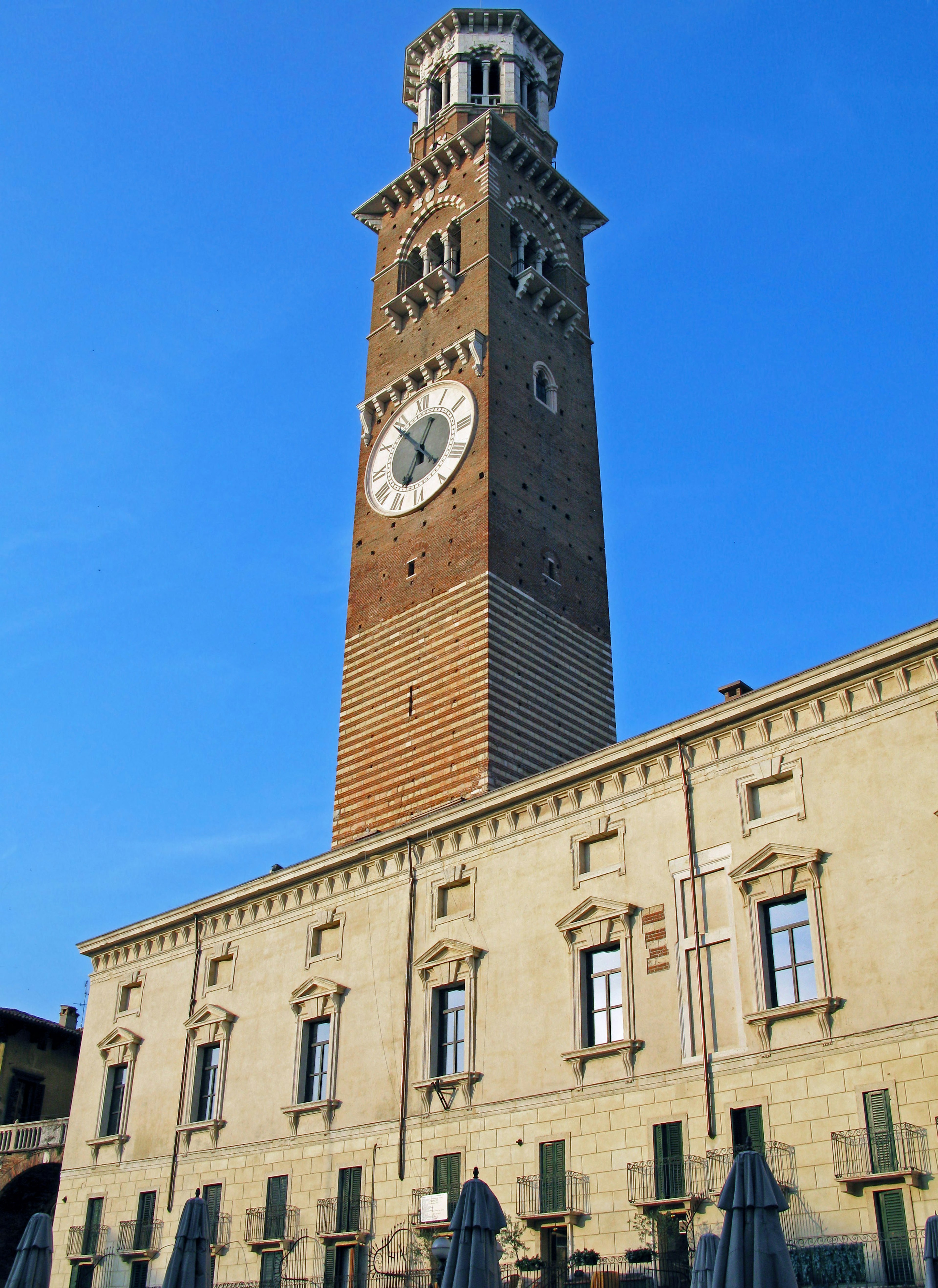 Historic clock tower in Verona under a blue sky