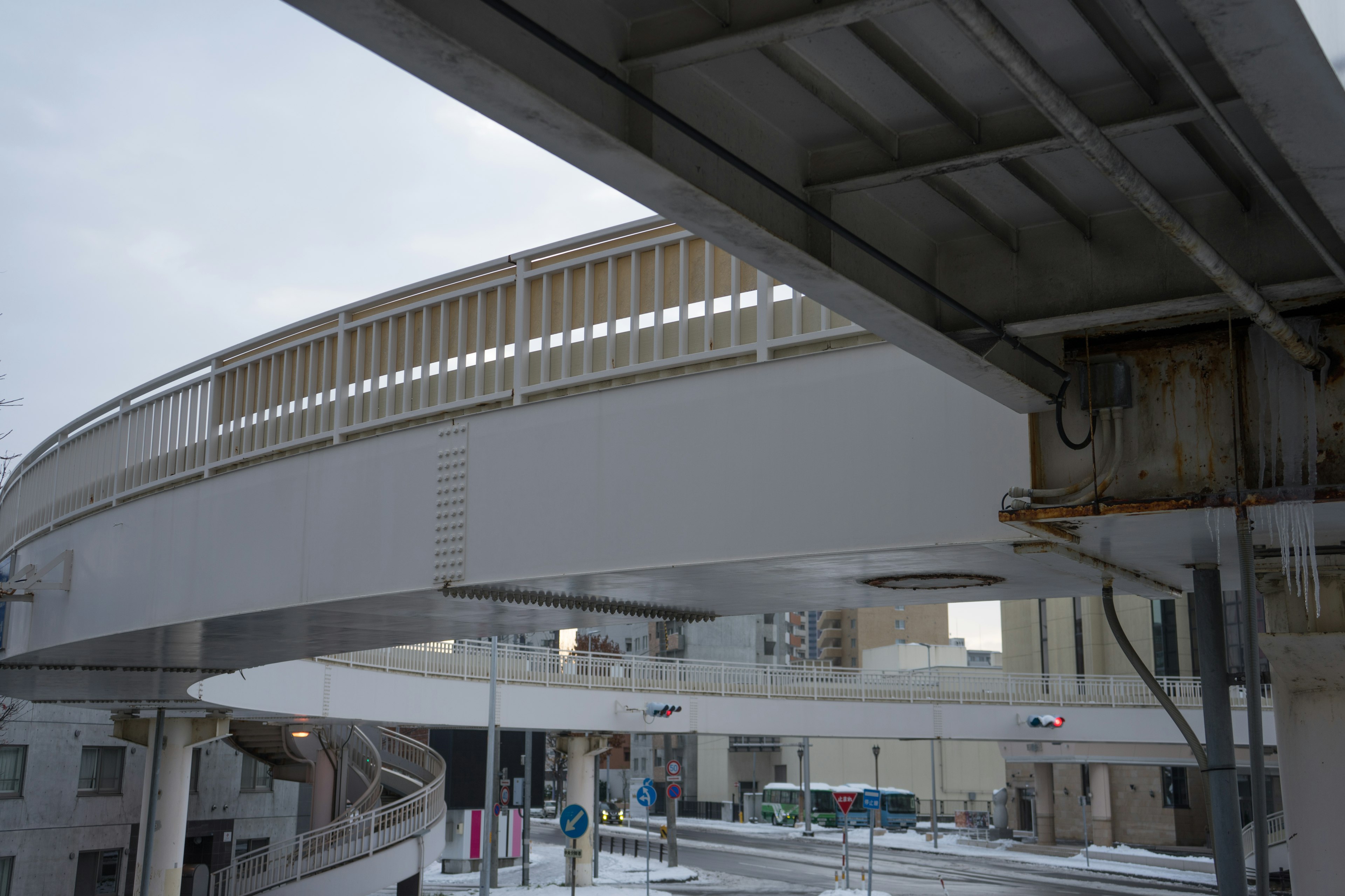 Photo of a white elevated bridge viewed from below