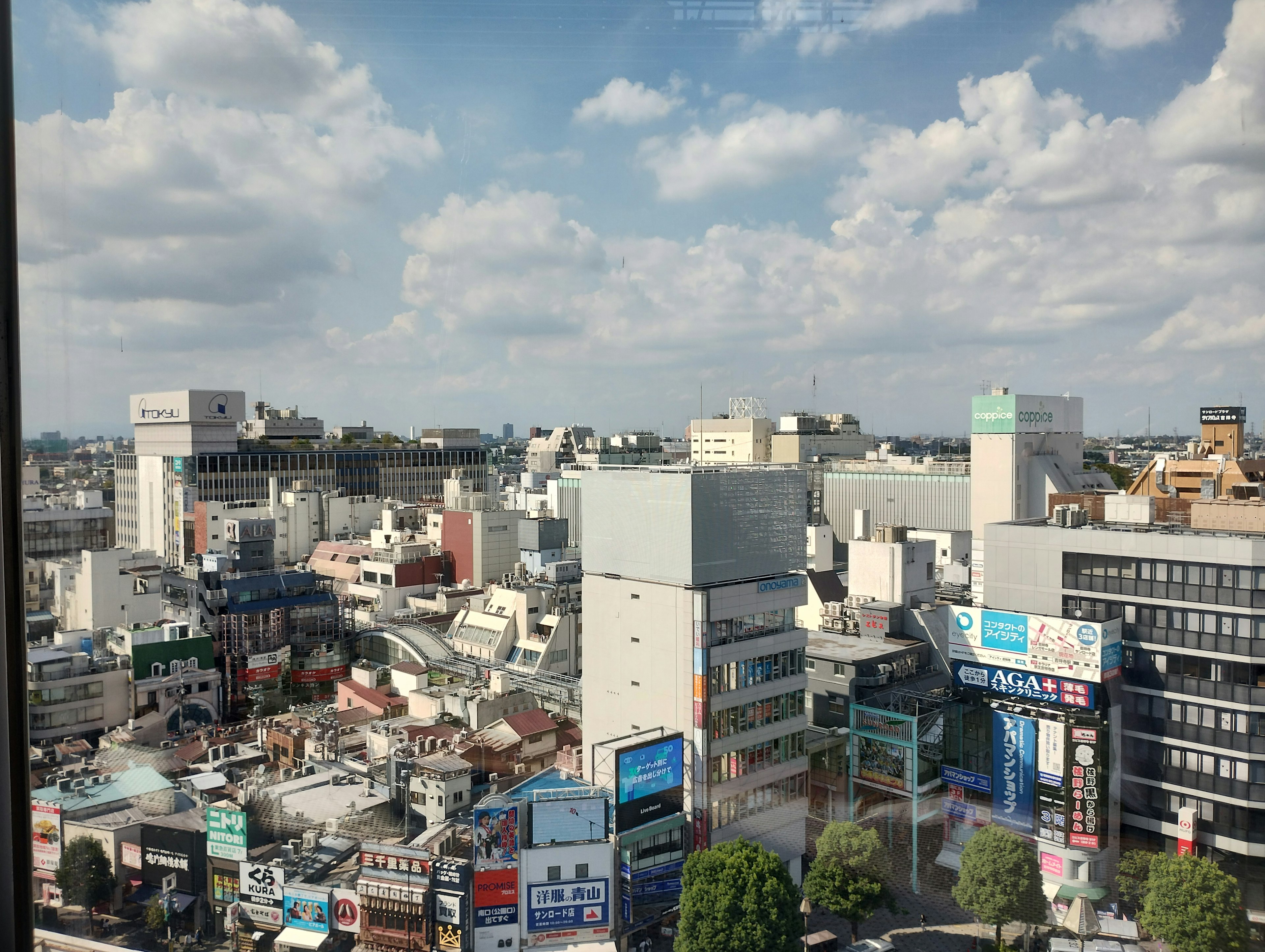 Cityscape featuring high-rise buildings and a blue sky