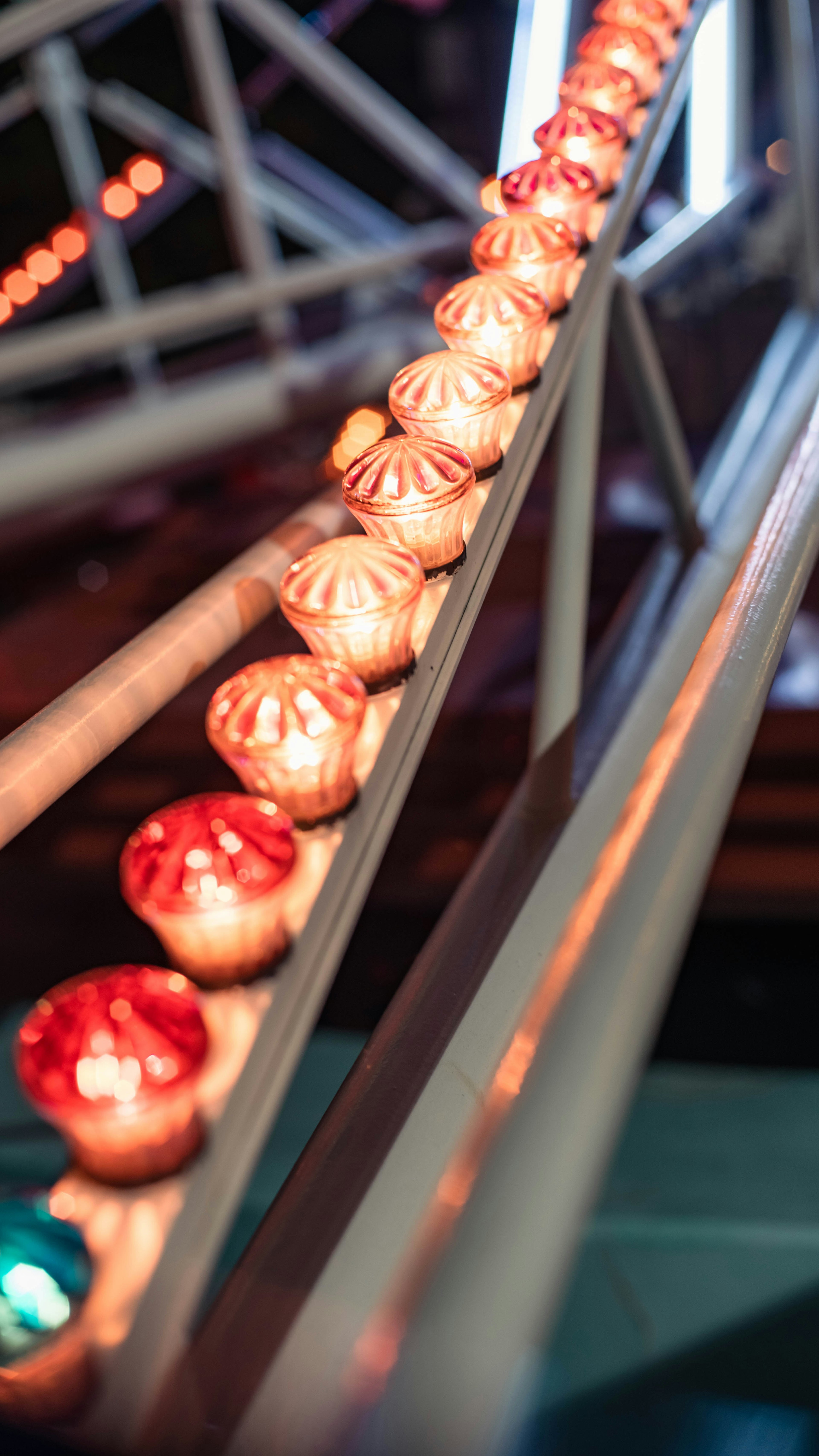 Colorful red and gold balls lined up on a carousel rail