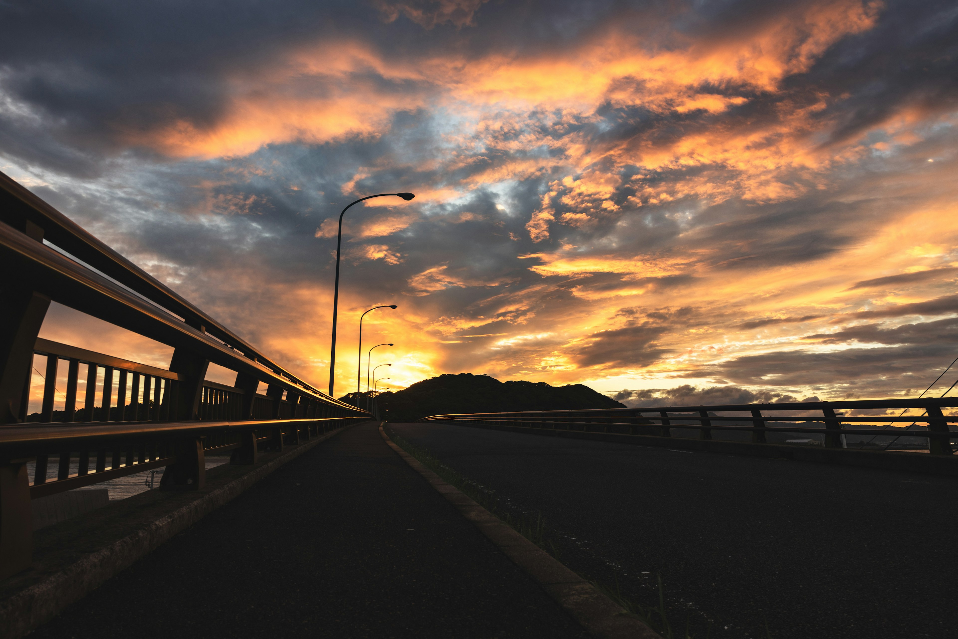 Scenic view of a bridge under a colorful sunset sky